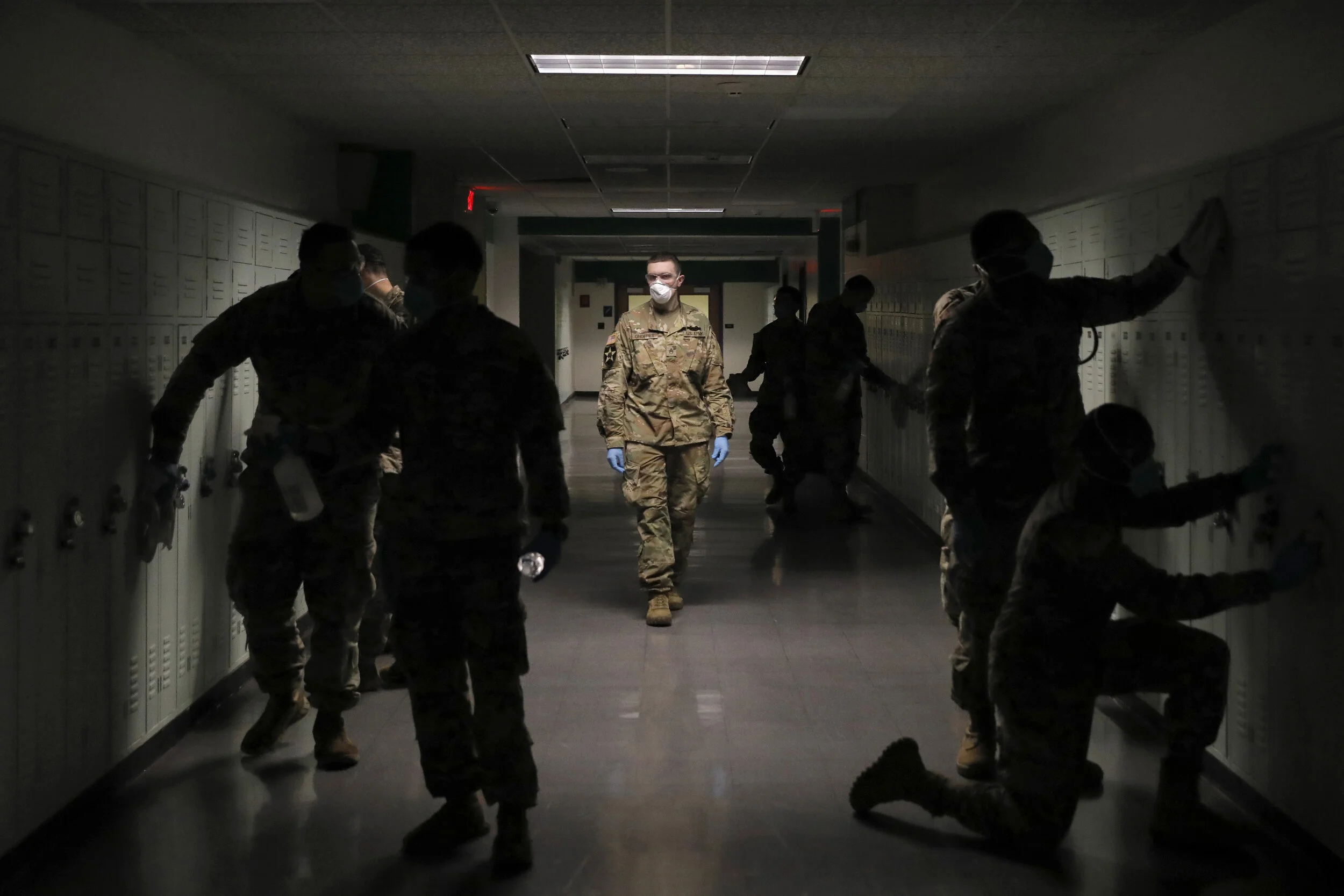  Members of the New York Air and Army National Guard work to disinfect the halls of New Rochelle High School. New Rochelle became one of the first areas in the state with a breakout of coronavirus and an exclusion zone was created to try to contain t