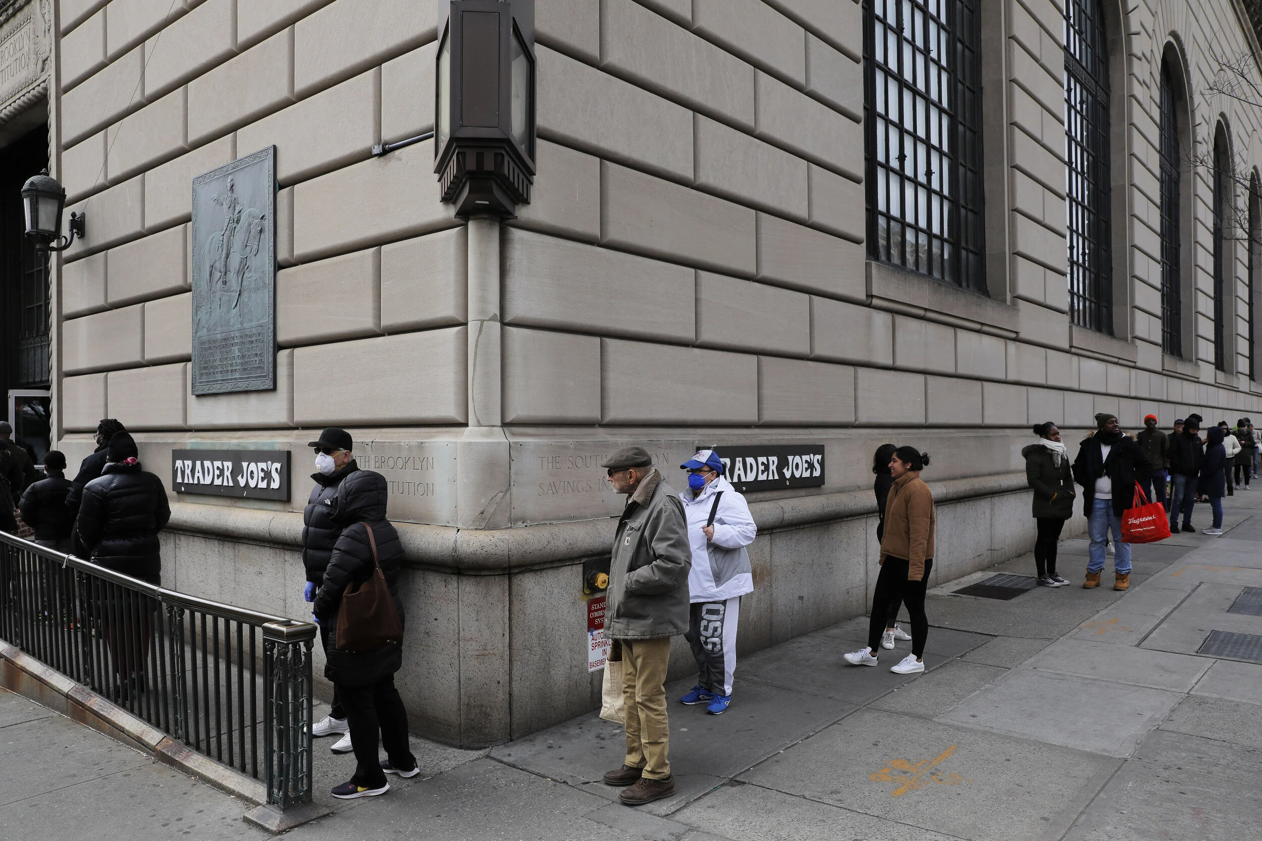  People are seen lining up to enter a Trader Joe’s supermarket in Brooklyn. Lockdown rules, social distancing rules and panic buying resulted in long lines to enter stores across the city. Shelves emptied as shoppers stocked up on essential items. 