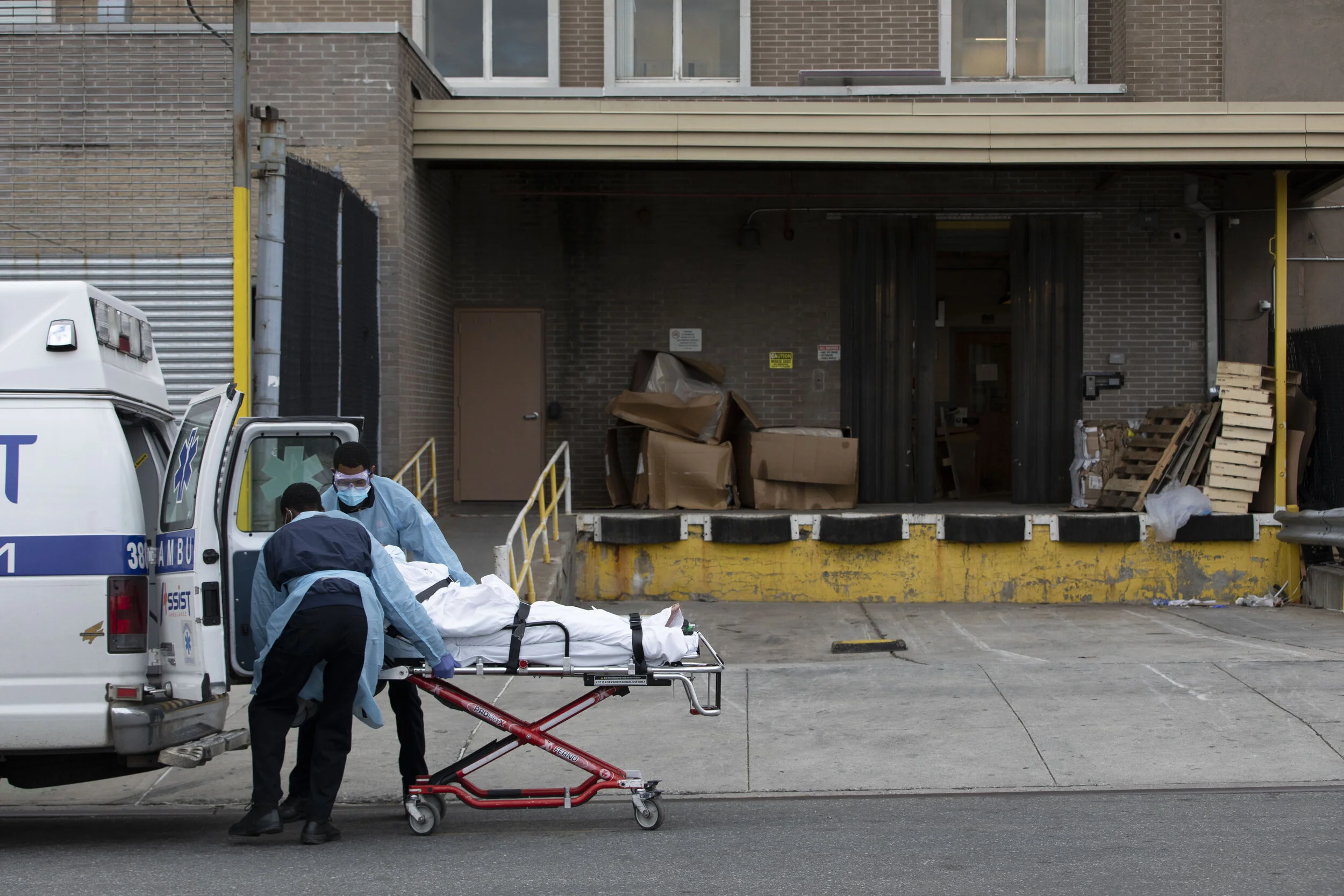  A person is unloaded from an ambulance near a loading dock at the Wyckoff Heights Medical Center in Brooklyn.  