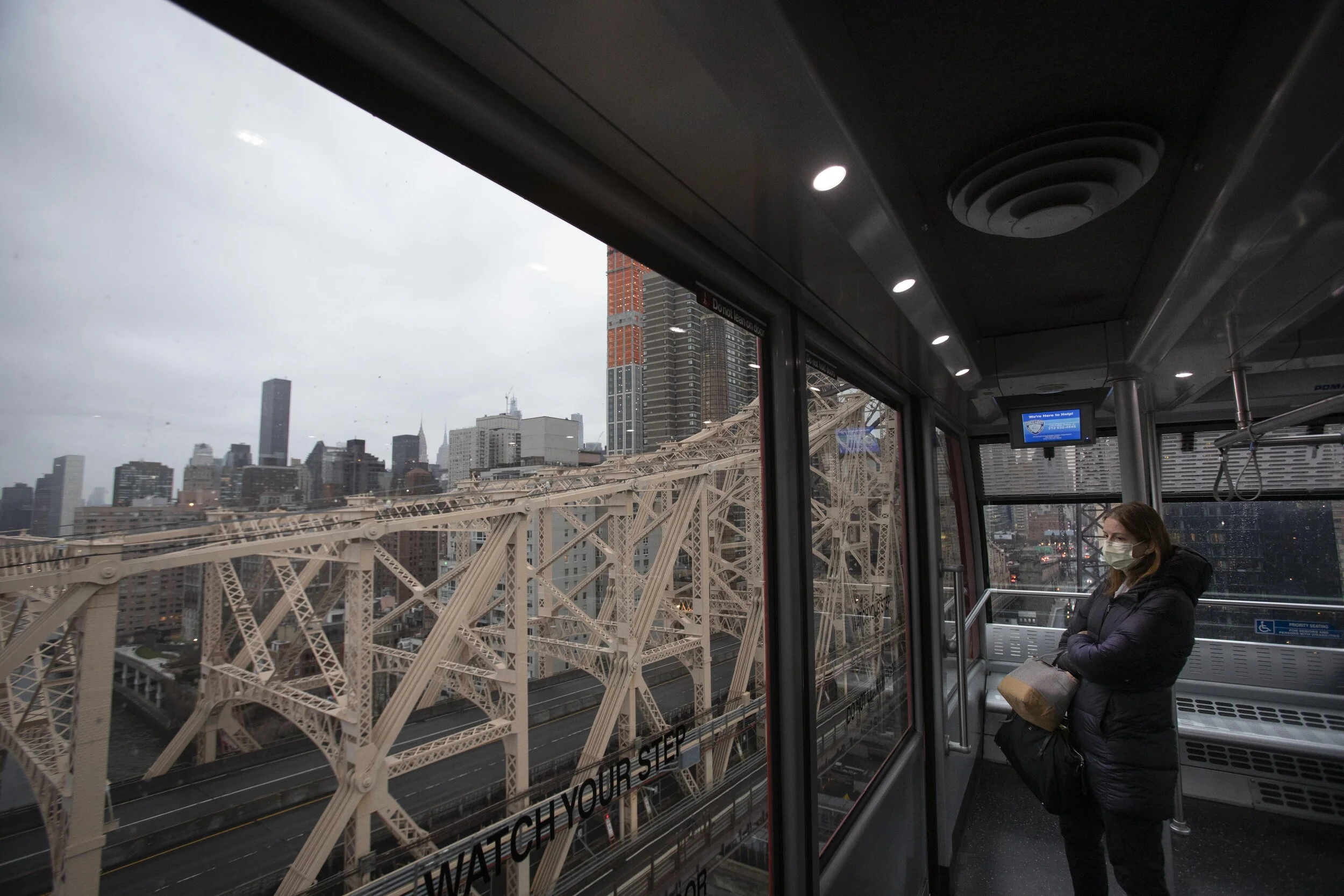  A passenger rides the Roosevelt Island Tramway while looking over an empty Queensboro Bridge at 6:00 pm on a Saturday night. With lockdown orders in effect, major arteries into Manhattan sat emptied. 