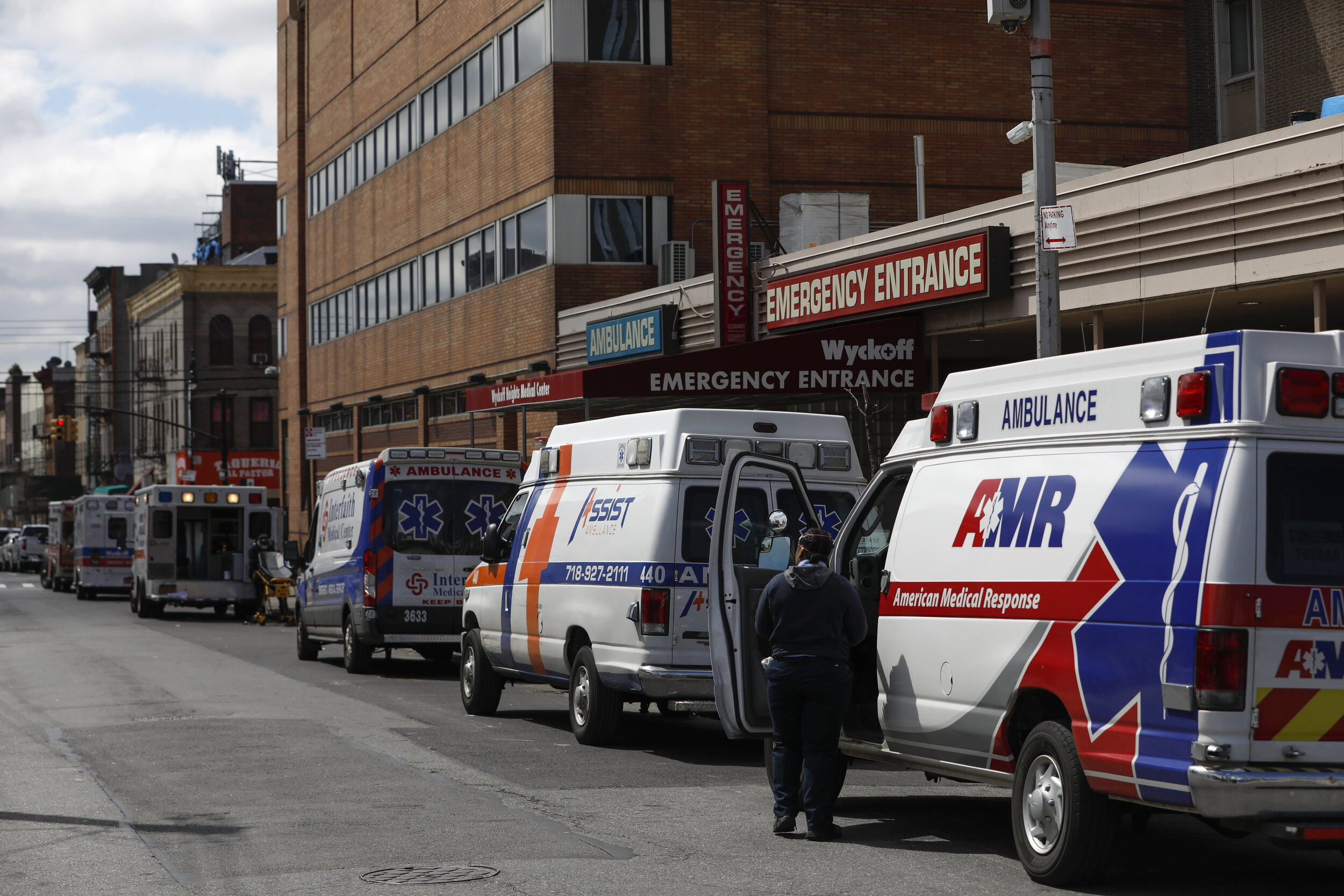  Ambulances queue outside the emergency entrance of the Wyckoff Heights Medical Center in Brooklyn. As the city emptied, one constant was the sound of sirens.  
