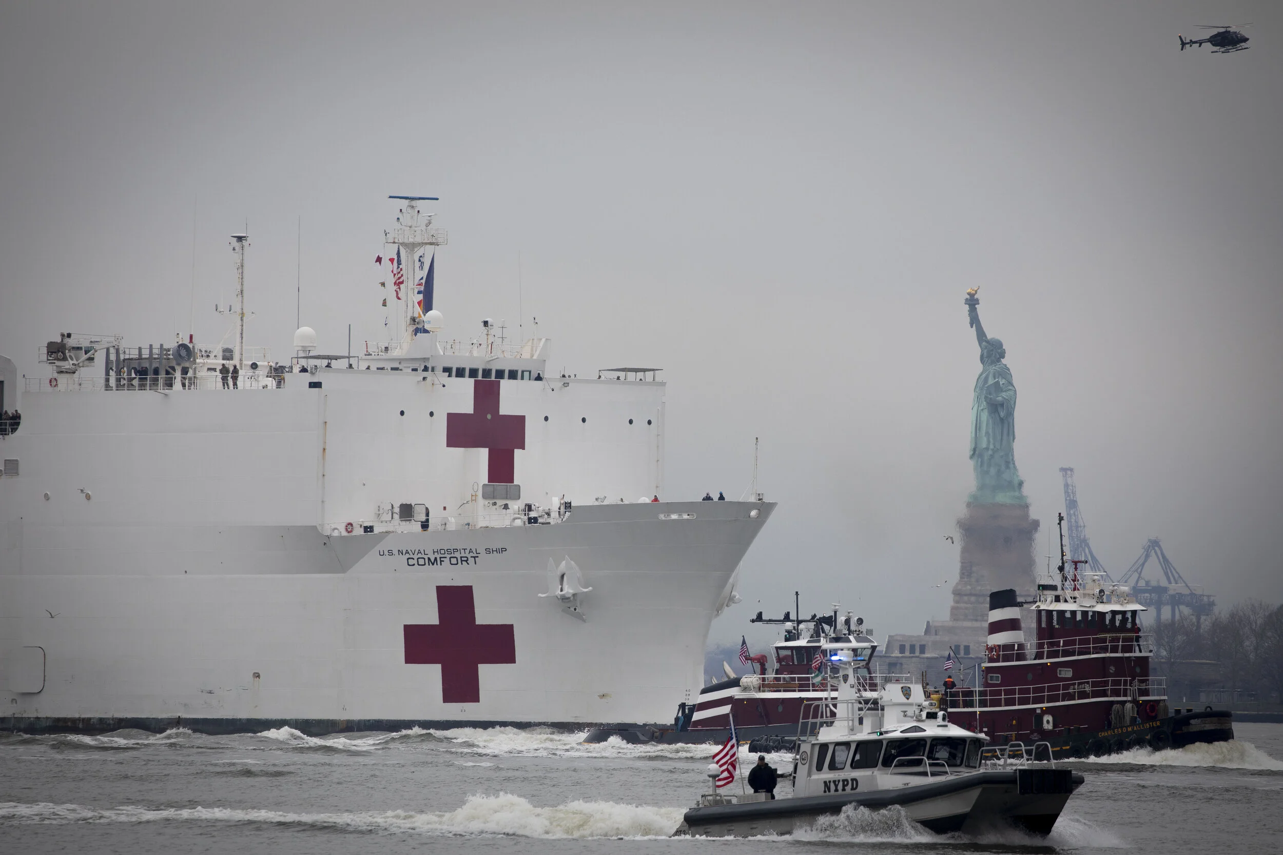  The USNS Comfort, a Navy hospital ship, is escorted by the Statue of Liberty as it arrives in New York City. The ship was sent to assist with anticipated overflow of patients from New York hospitals.  