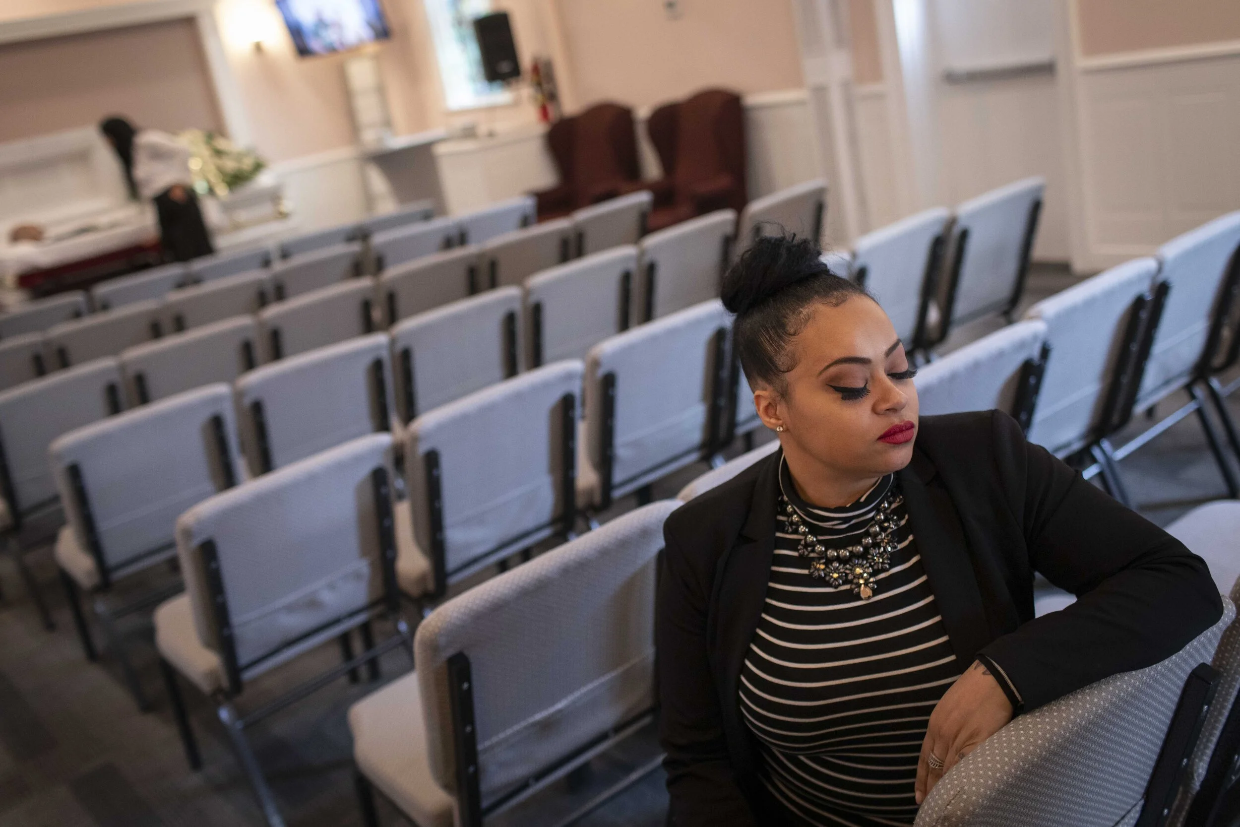  Jenny Adames sits in the chapel after a viewing service concludes. The funeral home is the only one in the city to offer viewing services in the time of coronavirus. Attendance is limited to 10 people at a time.  