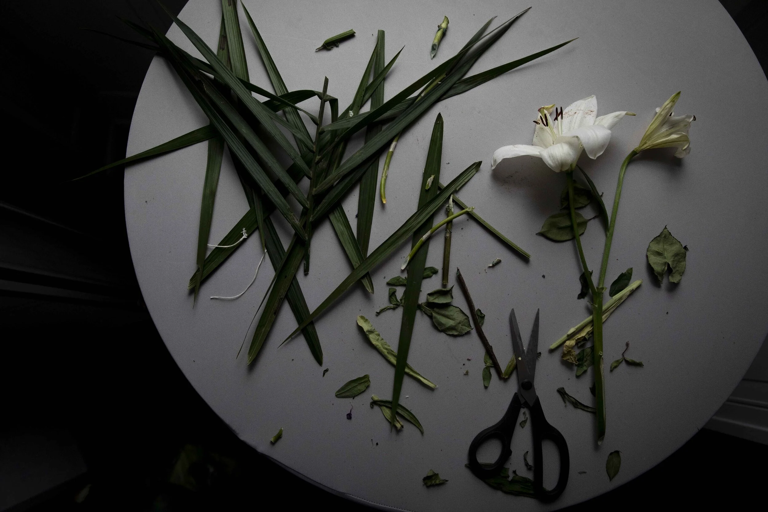  Flower trimmings sit in the chapel after being cut from a casket spray, the floral arrangement that sits on top of a casket at a funeral.  