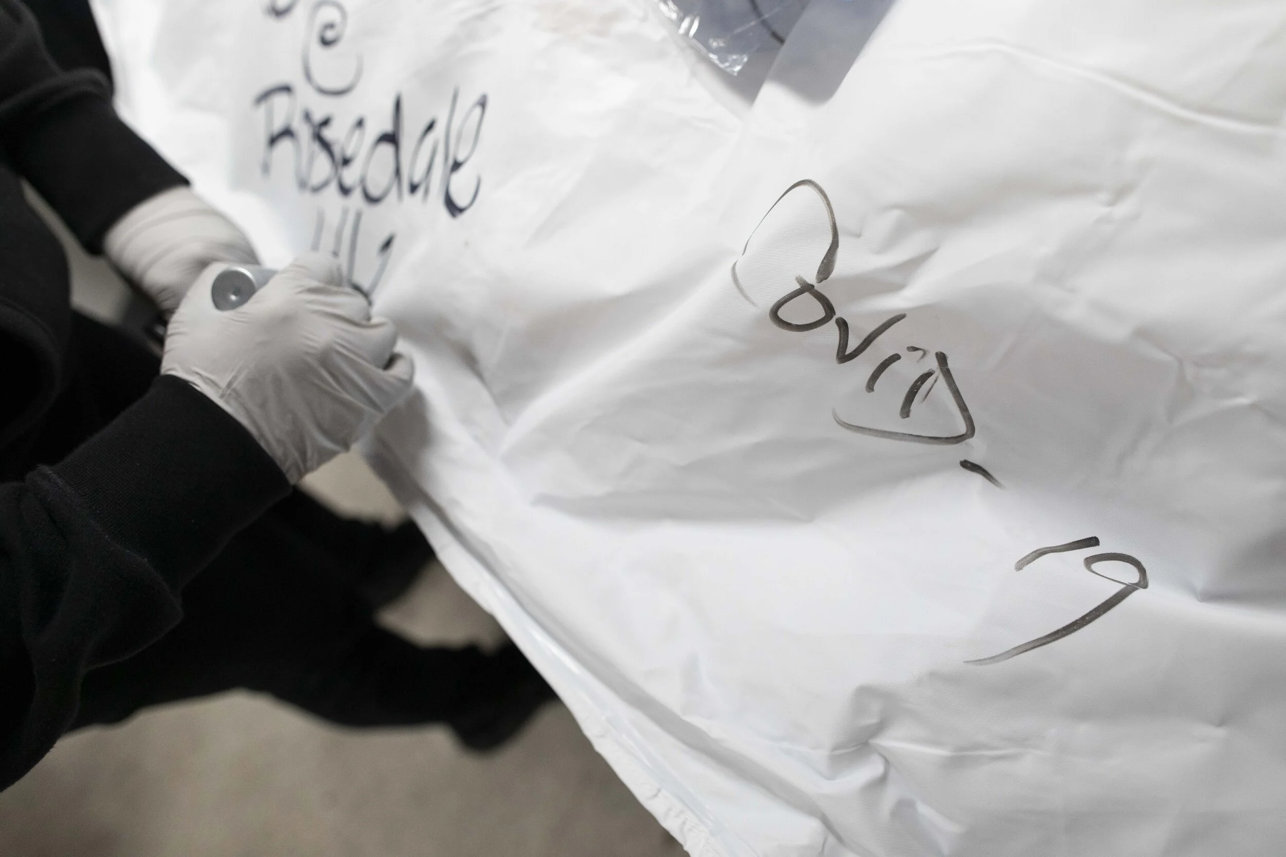  A body bag is marked with COVID-19, ensuring extra precautions are taken when handling it. It was unknown if victims of coronavirus remained contagious after their death.  