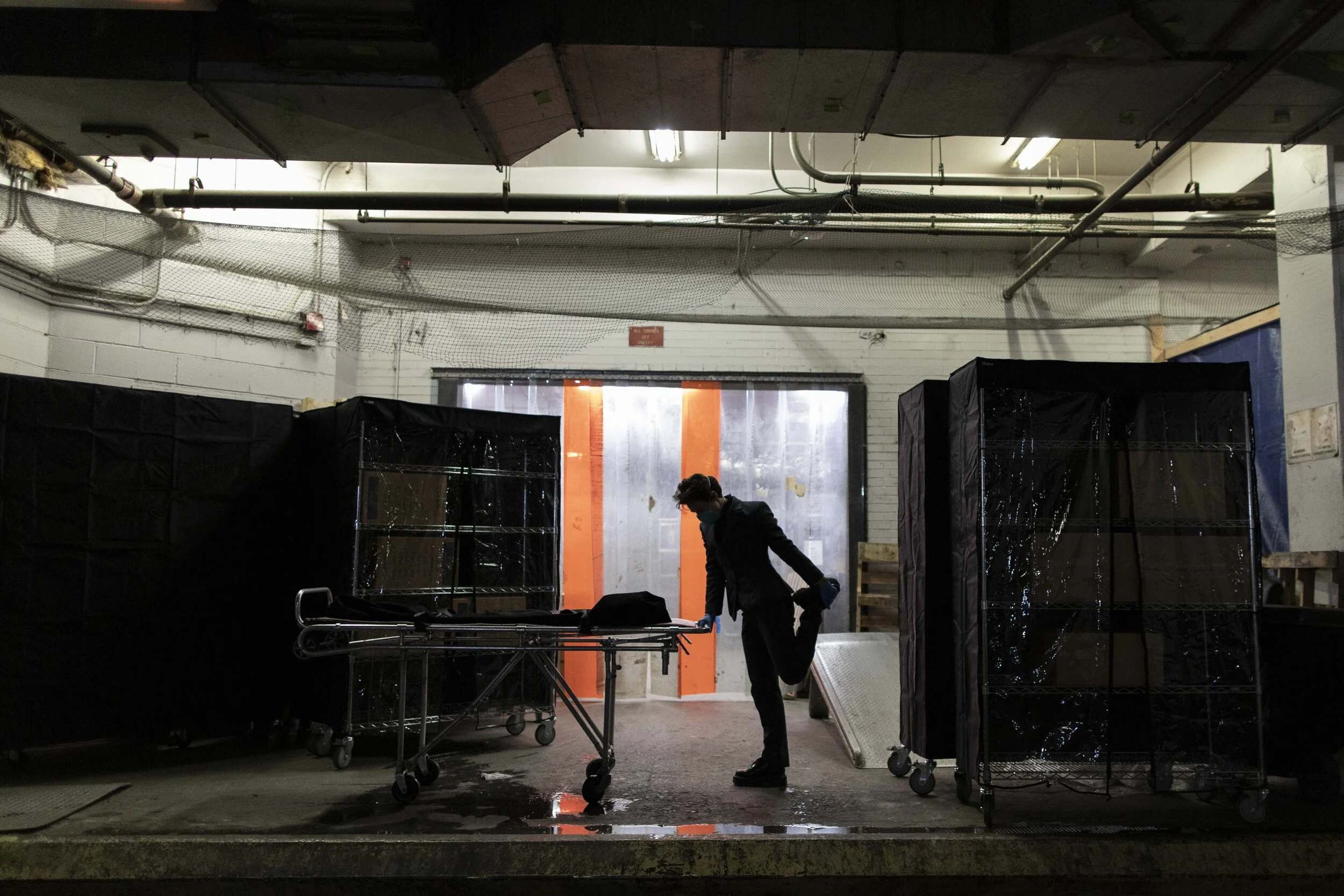  Lily Sage Weinrieb stretches ahead of collecting a body from an Upper East Side hospital. Lily worked into the night making collections, sometimes clocking up 18 hour work days.  