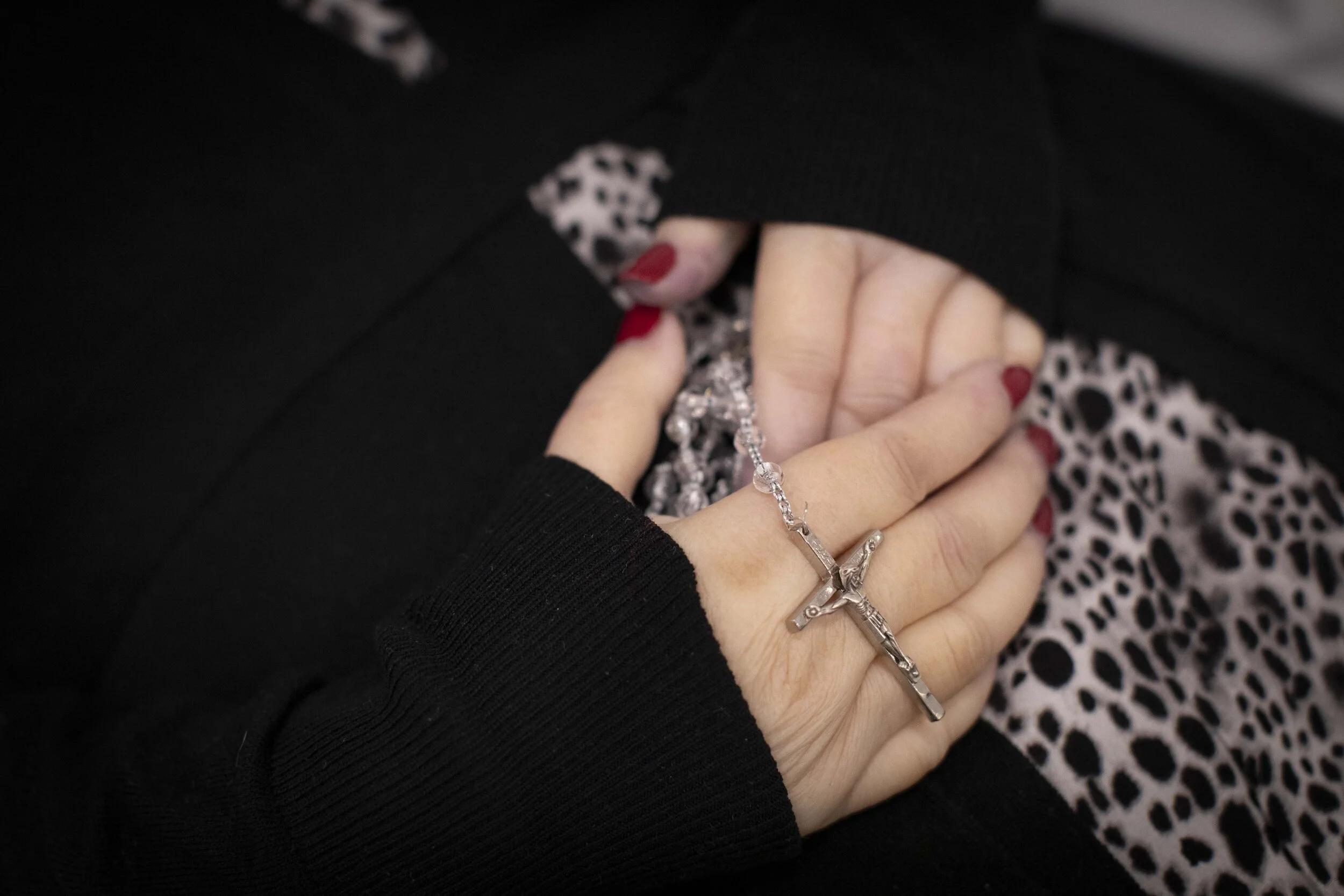  Rosary beads are seen placed in the hand of a victim of coronavirus before their viewing service held at International Funeral  Cremation Services in Harlem.  