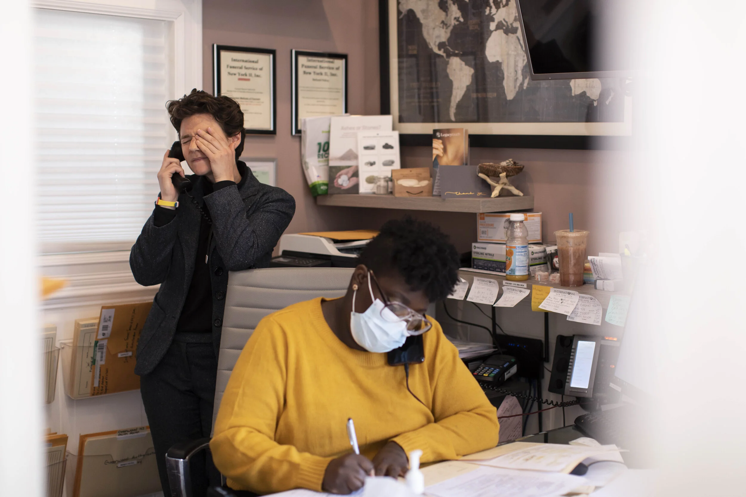  Lily Sage Weinrieb and Nicole Warring take calls in the office. The phones would ring non stop with people desperate to find a place for their loved ones as the death rate in the city peaked at around 800 per day.  