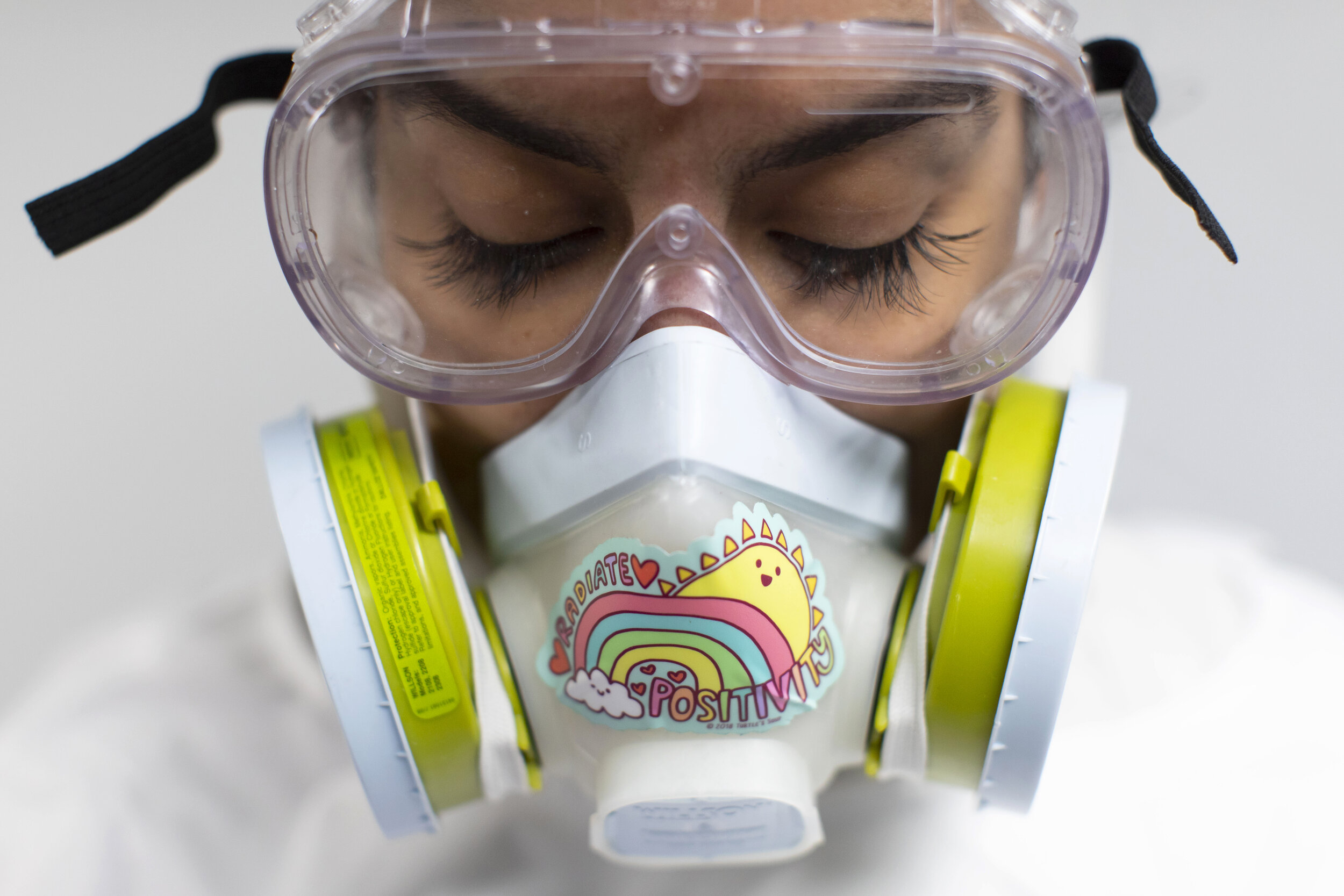  Alisha Narvaez wears PPE ahead of an embalming session.  