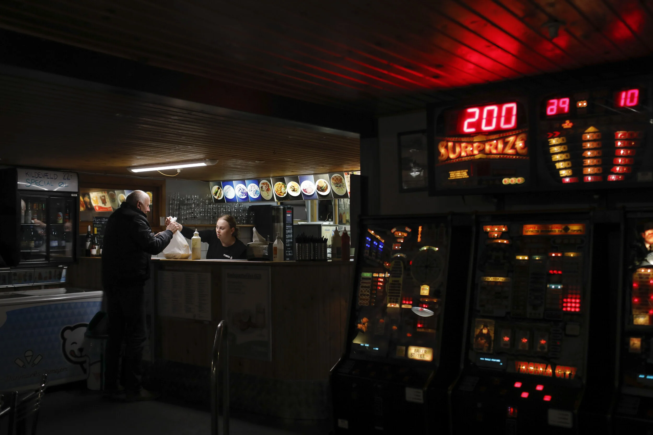  A person purchases a meal at the the Polseboden, a food stall that sells hotdogs and fish dishes in the harbor in the village of Thyboron in Jutland, Denmark.  