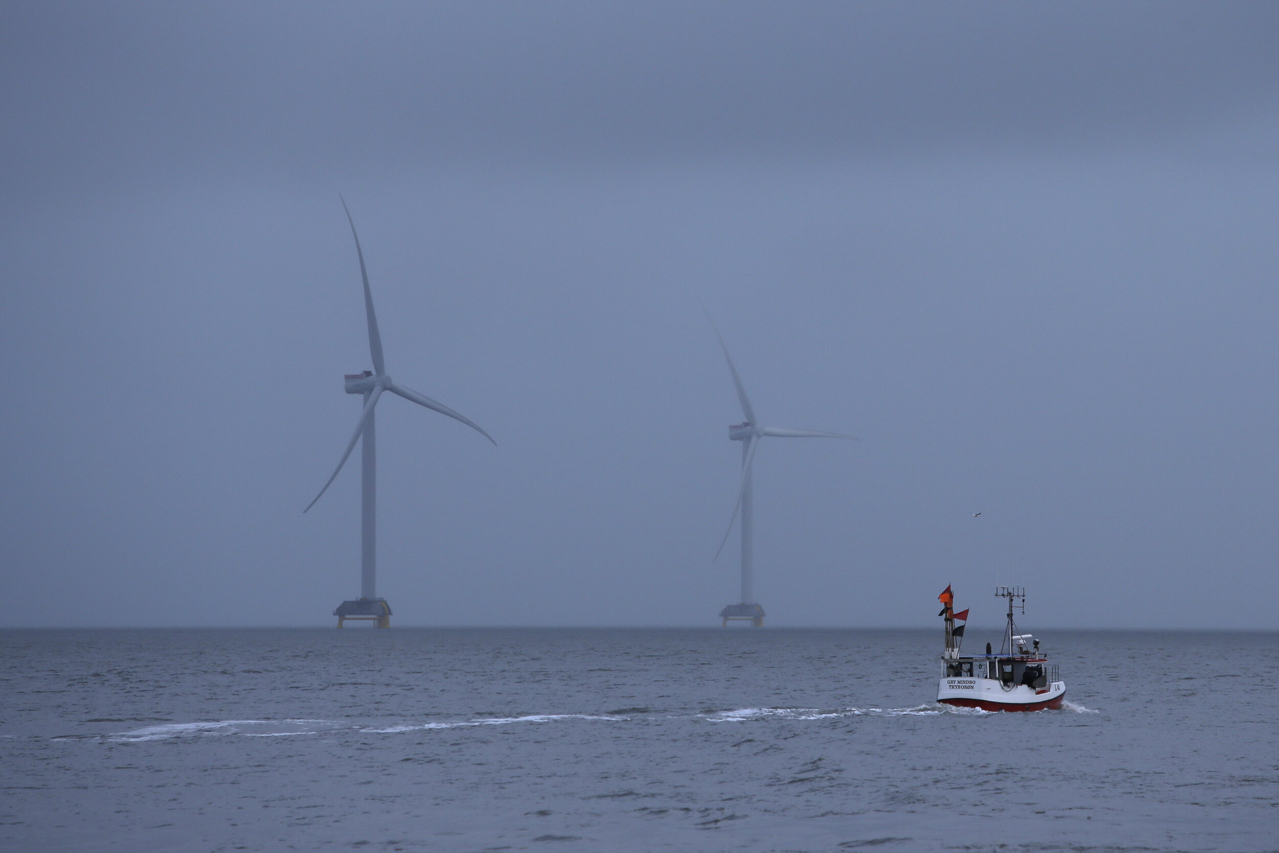  A fishing vessel makes its way past wind turbines in the Thyborøn Canal. With high winds in the region, wind turbines are plentiful along the west coast of Jutland, a region where that particular source of energy is highly utilized. 