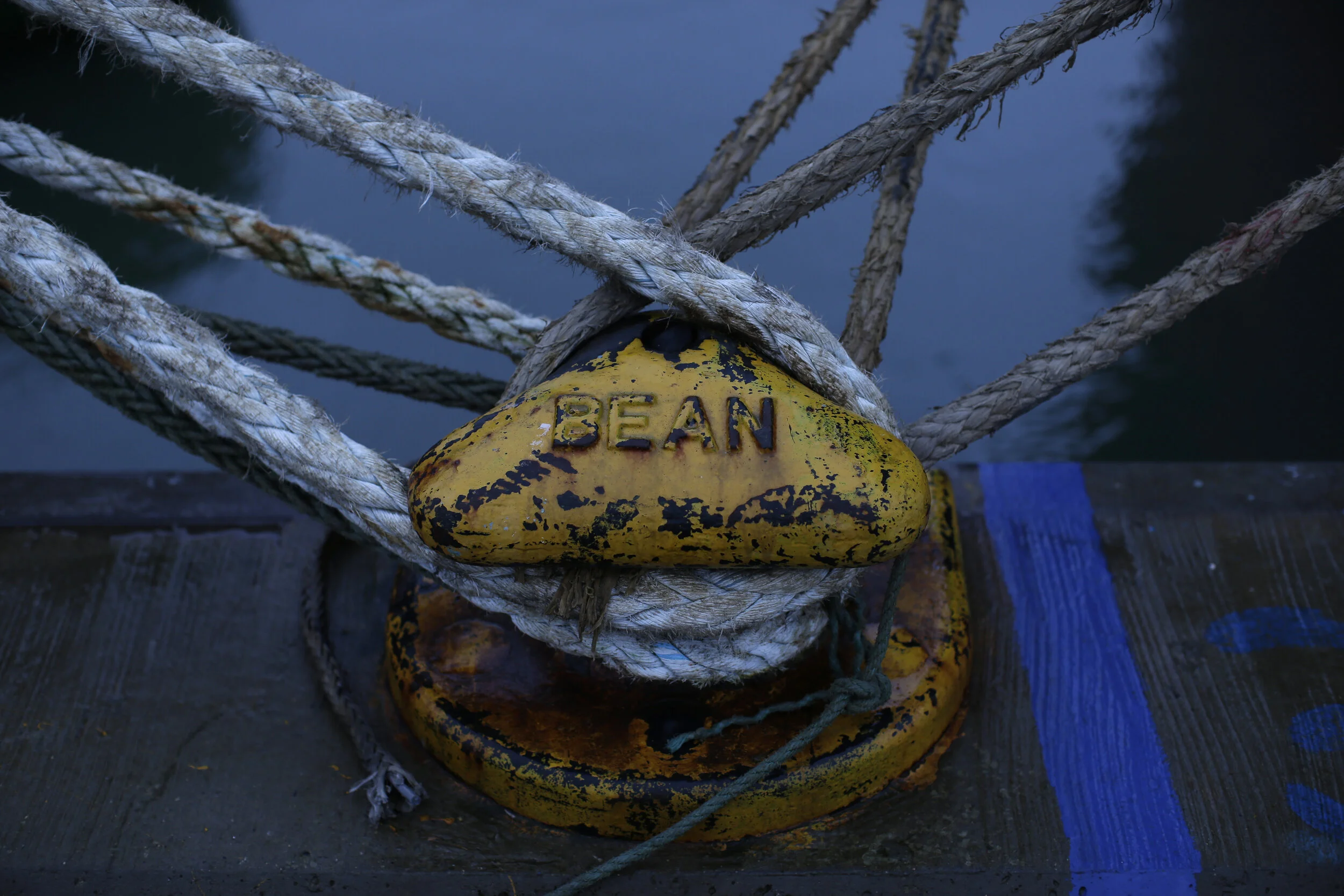  Ropes of ships are tied to mooring bollards in the port of Thyborøn.  
