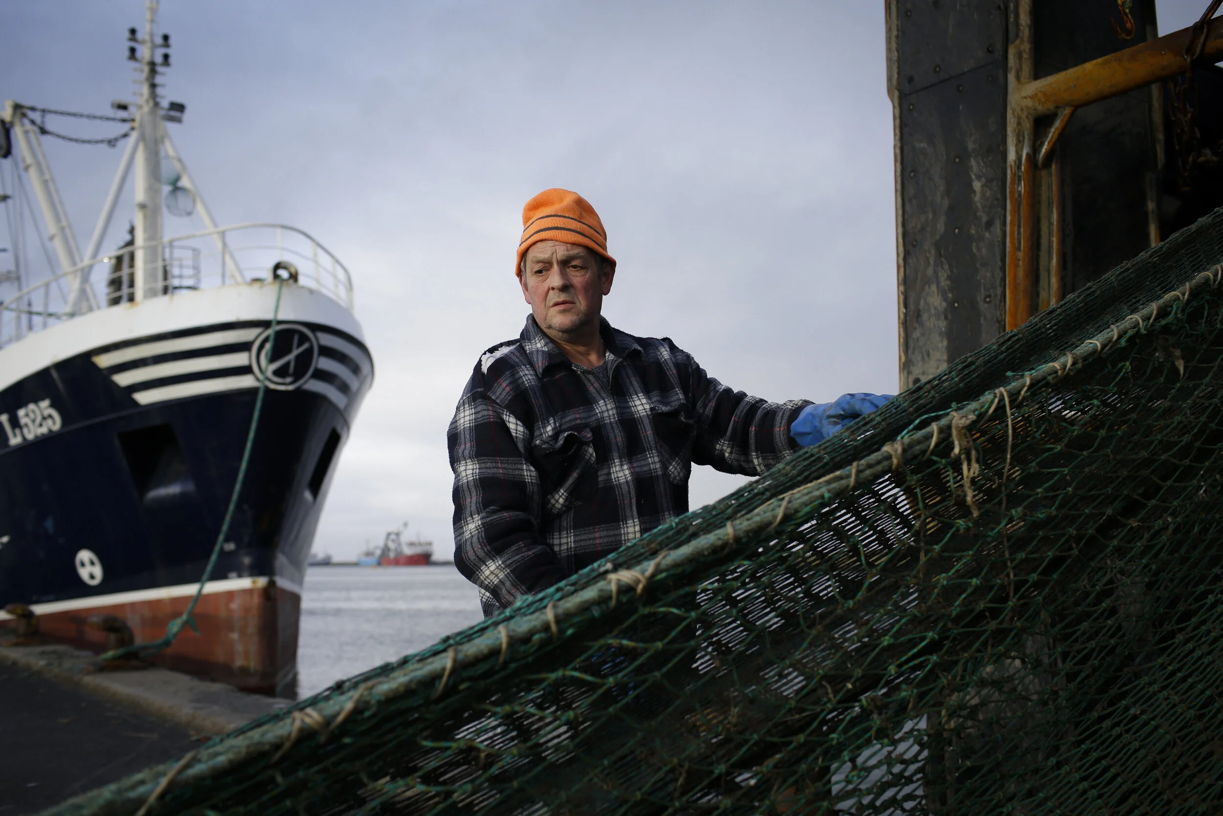  Allan Jorgensen, who has been a fisherman for 44 years, reels in the net of the fishing boat Linette shortly before departing for a two week fishing expedition. Sailors are typically out at sea for 10-14 days, depending on their catch.  