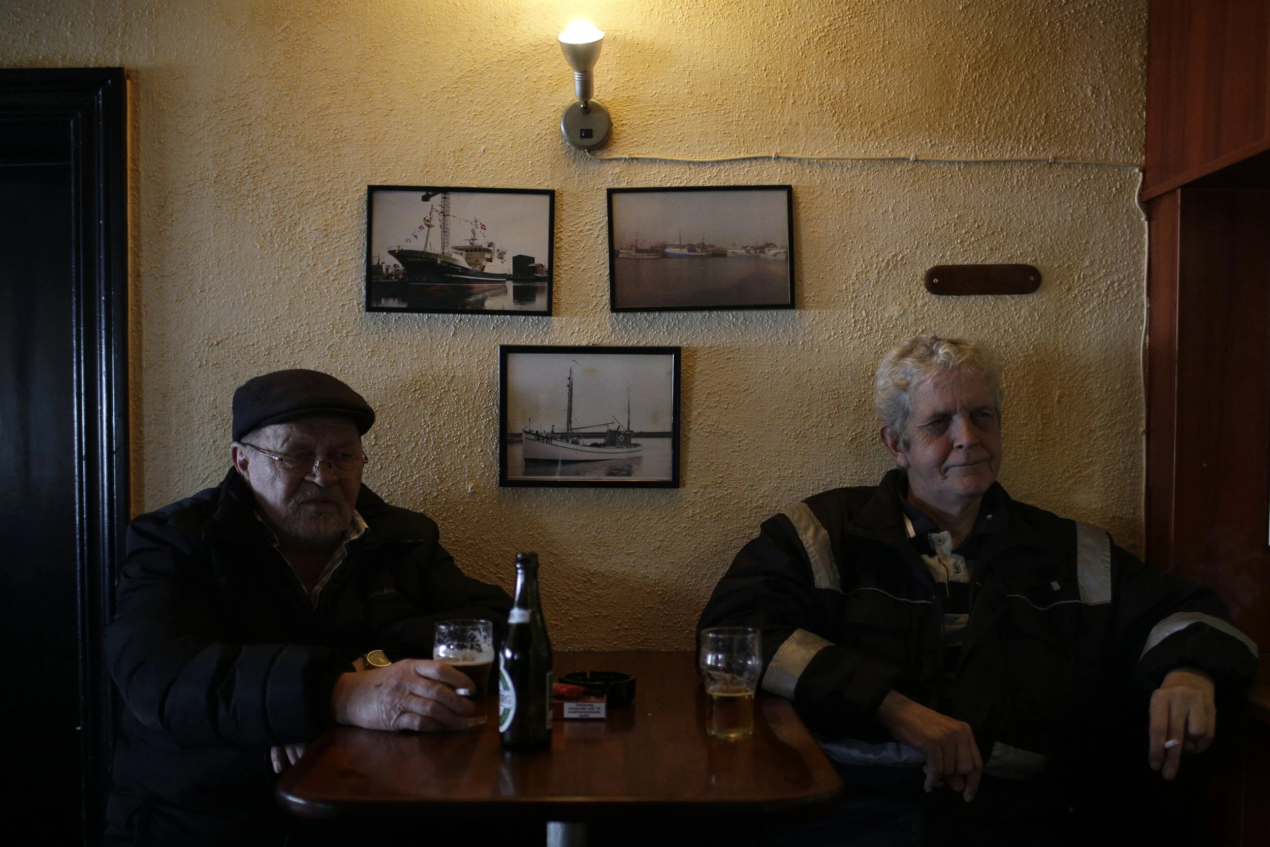  Retired fisherman Jorgen Gas (L) and fisherman Poul Kjeldsen sit in the Ankerpladsen, a pub popular with older and retired fisherman, in the village of Thyborøn in Jutland, Denmark. Across the street, the bar called The Canal is more popular with a 