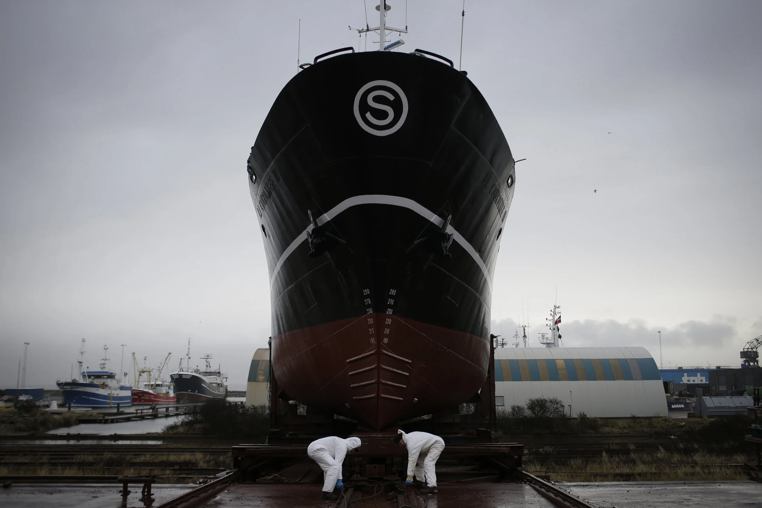  Viggo Andersen and Jesper Godtfredsen prepare to relaunch a ship at Thyboron Ophalerbedding, where ships are maintained and repaired, in the village of Thyborøn in Jutland, Denmark.  