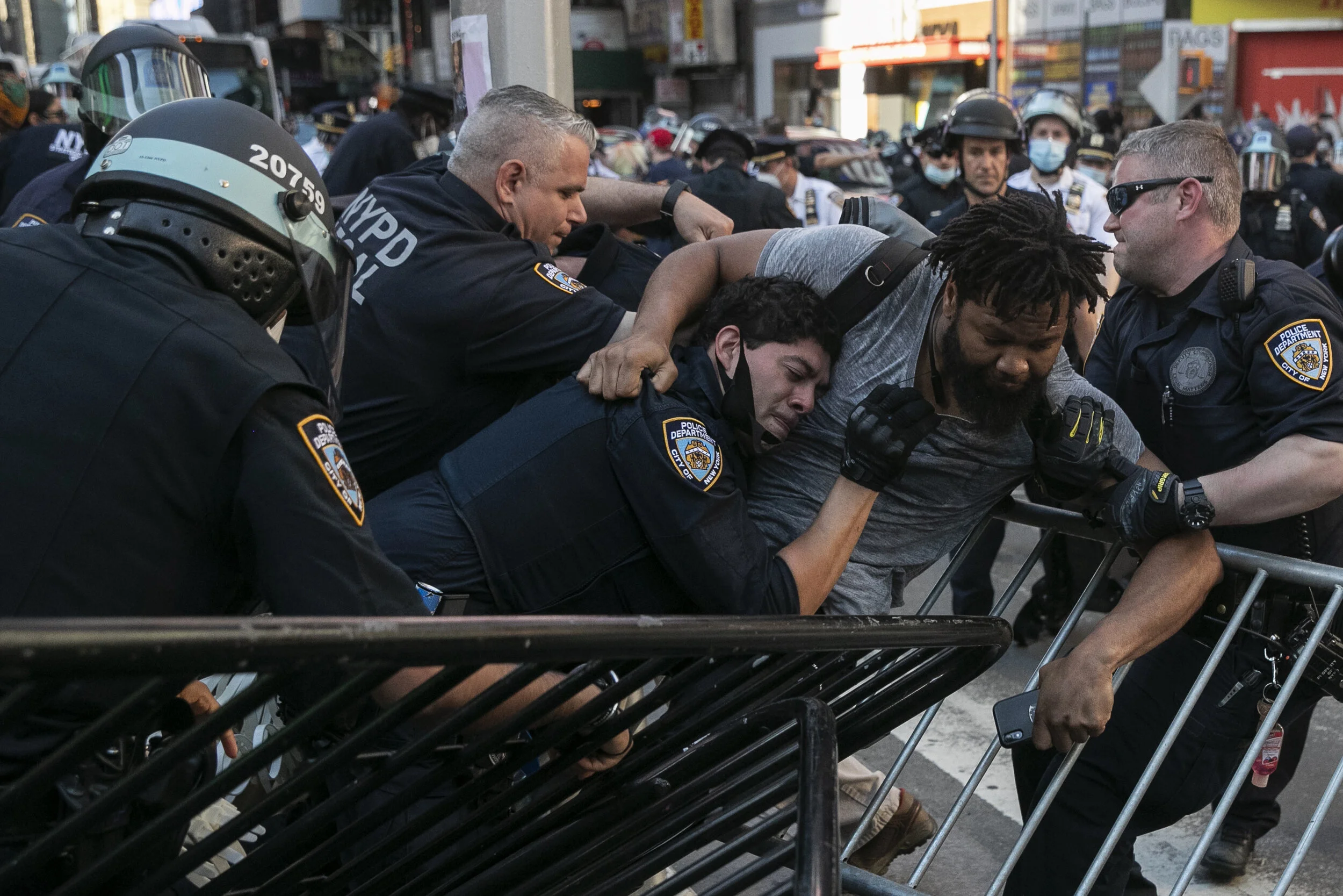  New York Police Department officers detain a protester in Times Square.  