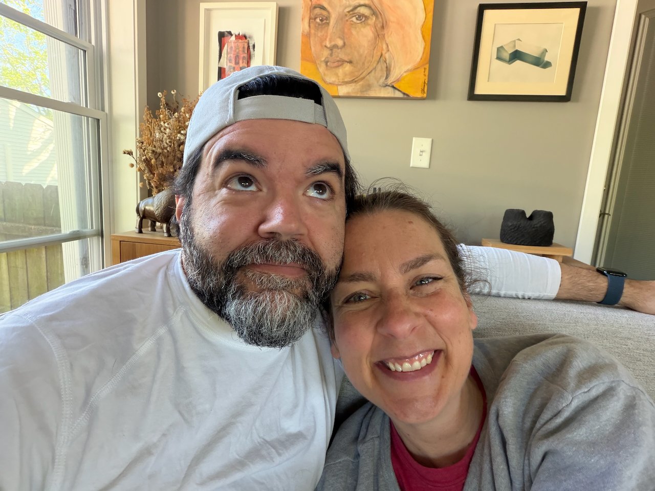 Nick and Laura Bergus pose for a selfie on a couch.