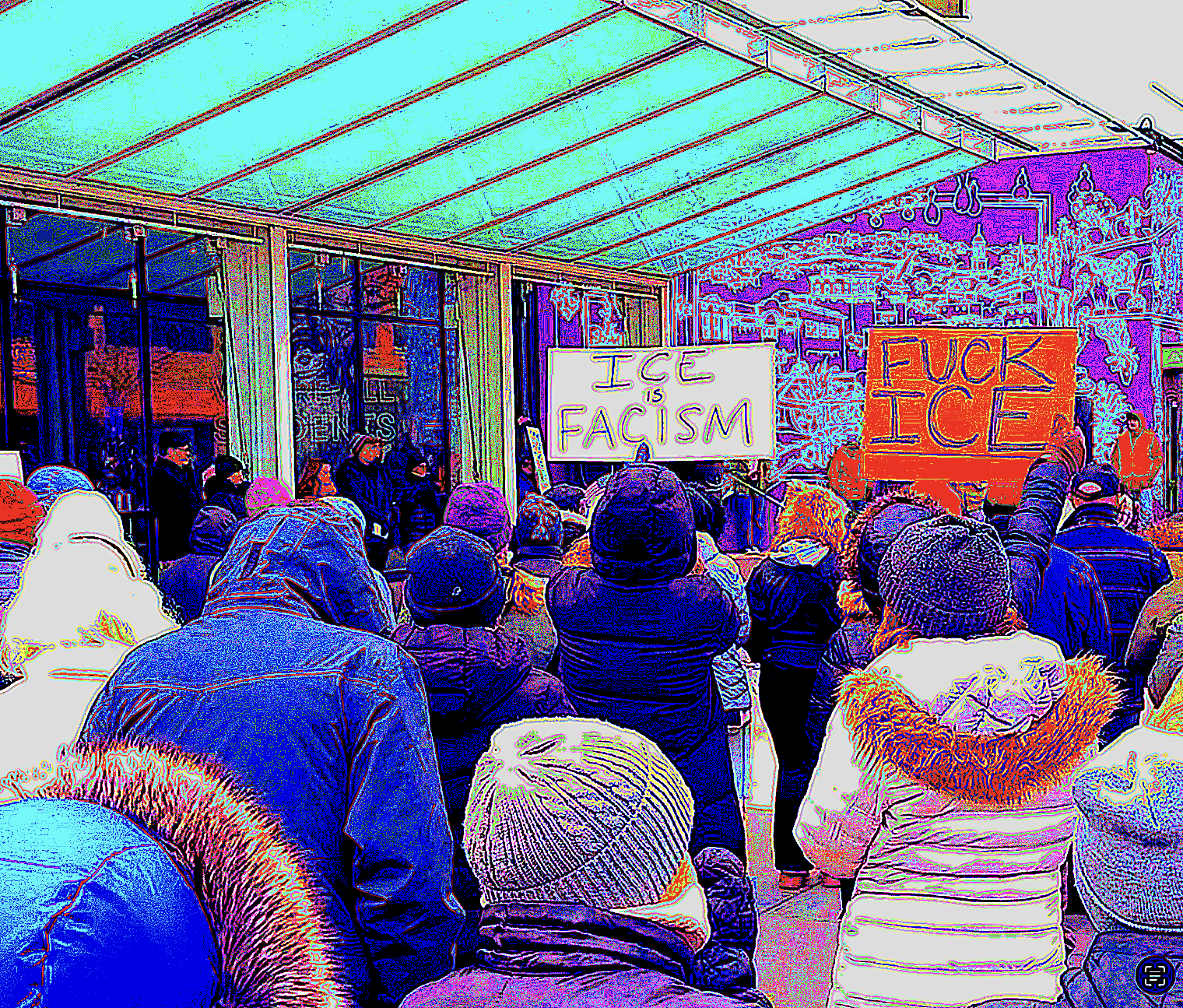 A distorted image of people attending a rally against ICE on the Pedestrian Mall in Iowa City.