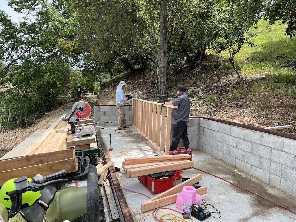 After installing a starter PT board on top of the vapor barrier, wall construction commenced