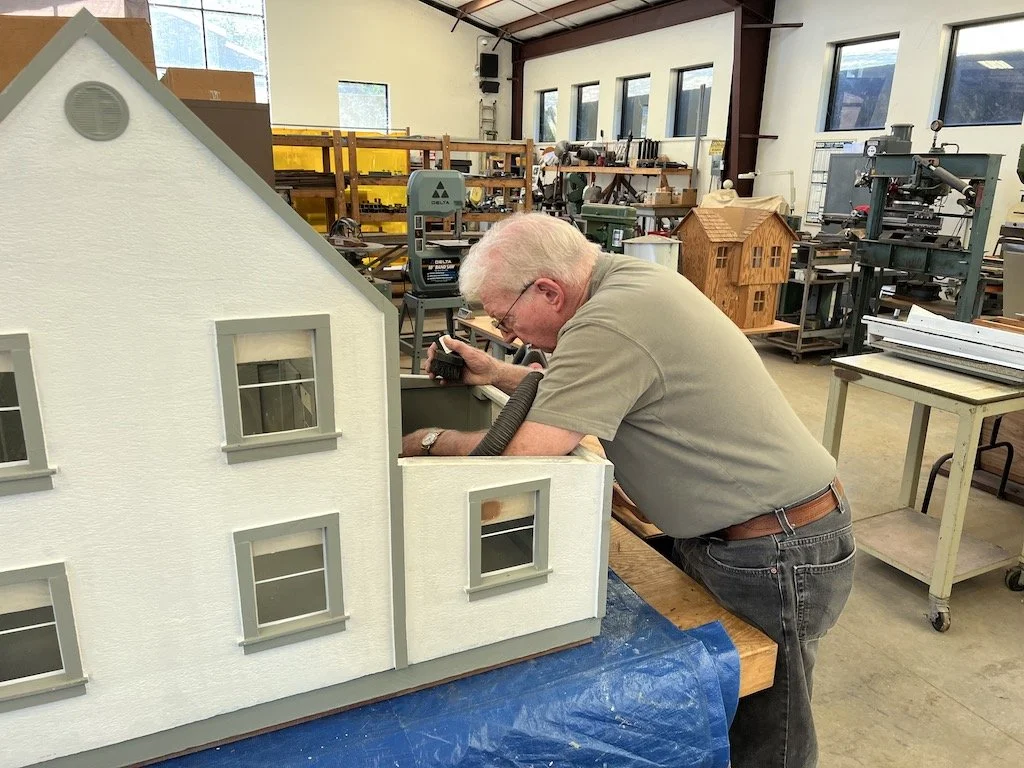 Ron vacuums the dust before painting