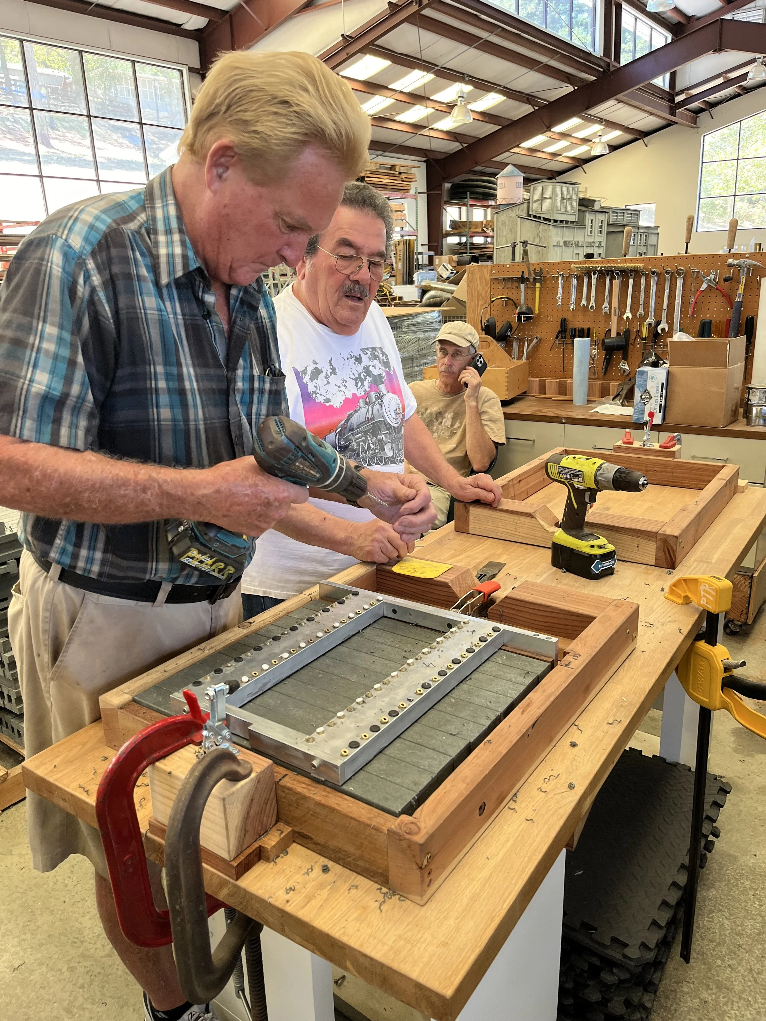 Carl clears out a broken drill from the tie drilling fixture