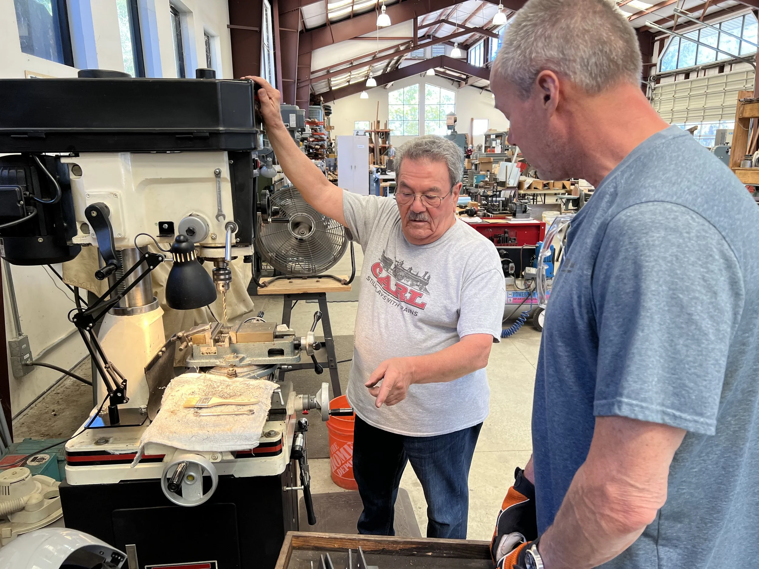 Carl shows Sam how to mill foundation clamps for the Roundhouse