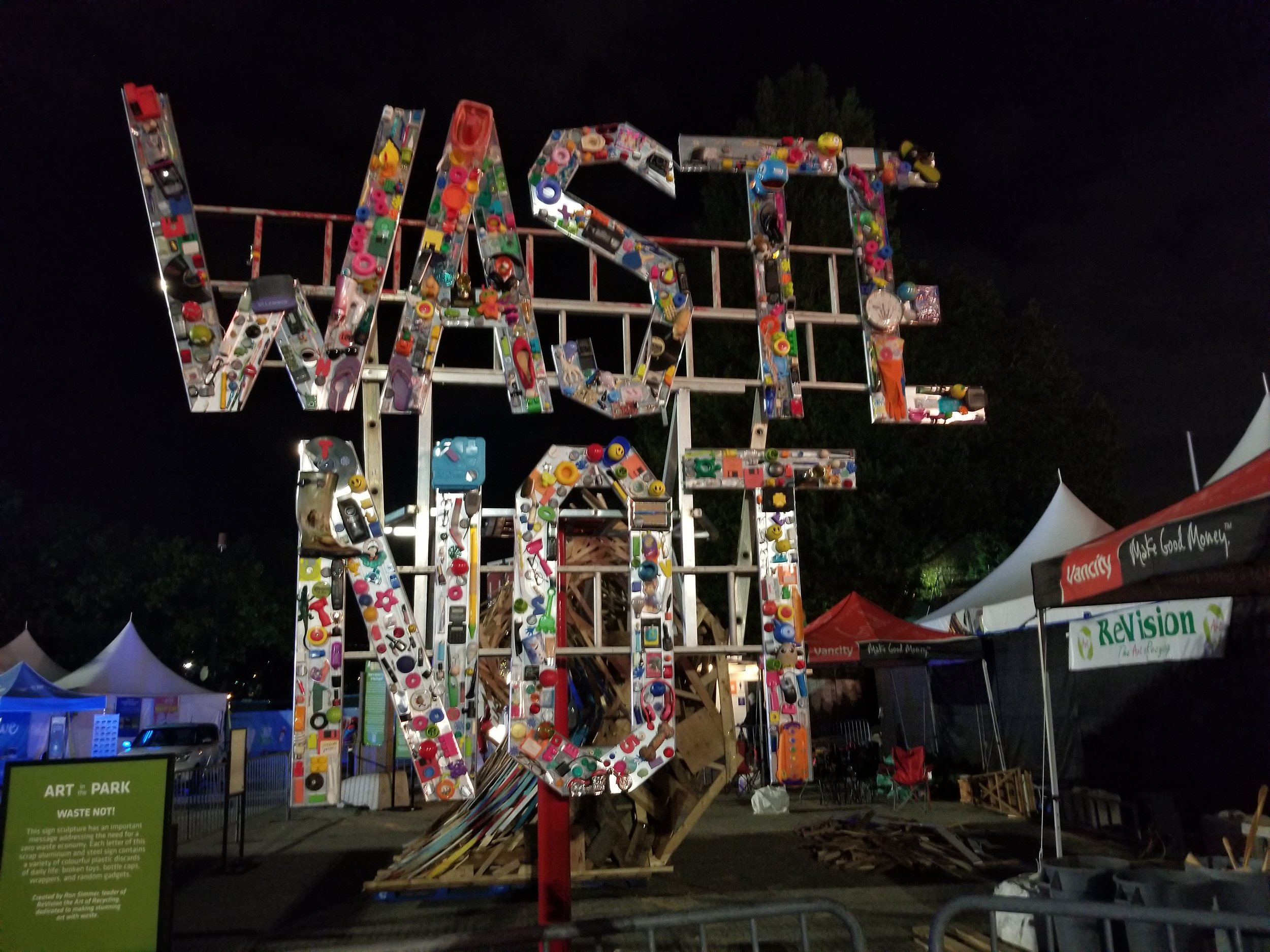 "Waste Not" sign at night