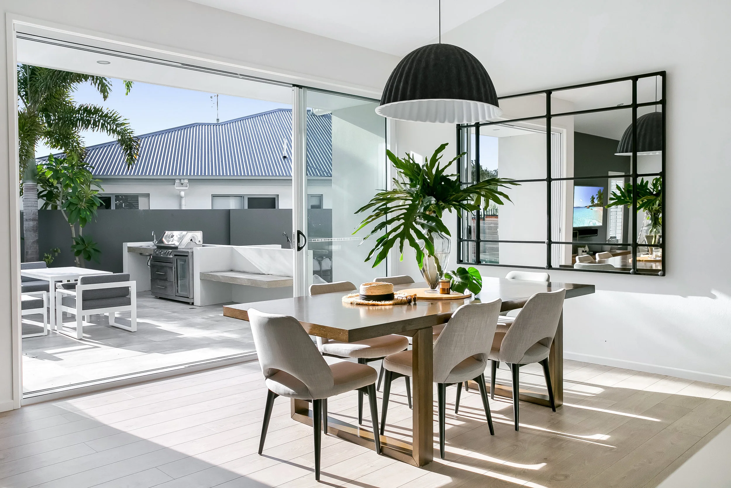 Stylishly styled dining room with outdoor views in a high-end holiday home, offering a premium experience above average coastal holiday rentals