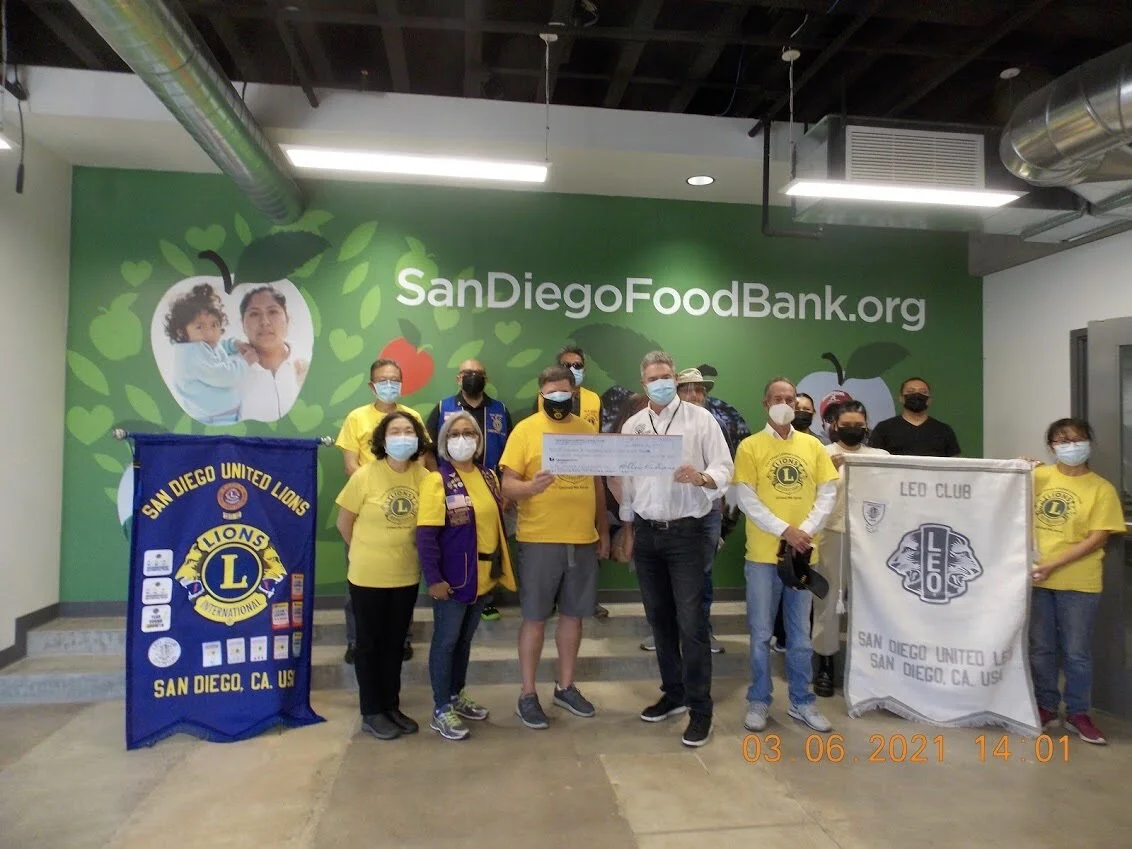 San Diego United Lions Club donates chicken and a check to the San Diego Food Bank