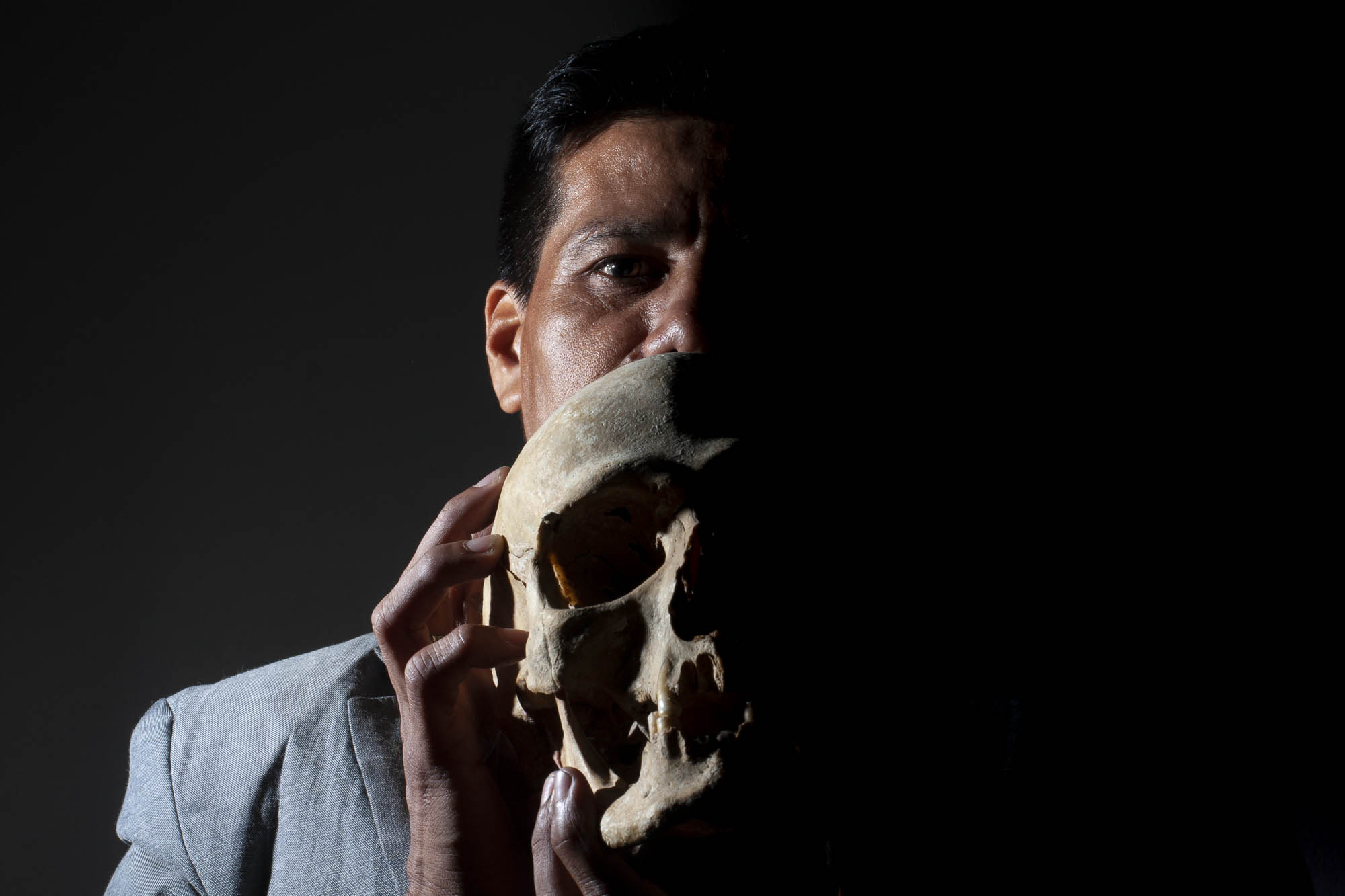  Israel poses for a portrait. He uses a human skull to conceal his identity. 
