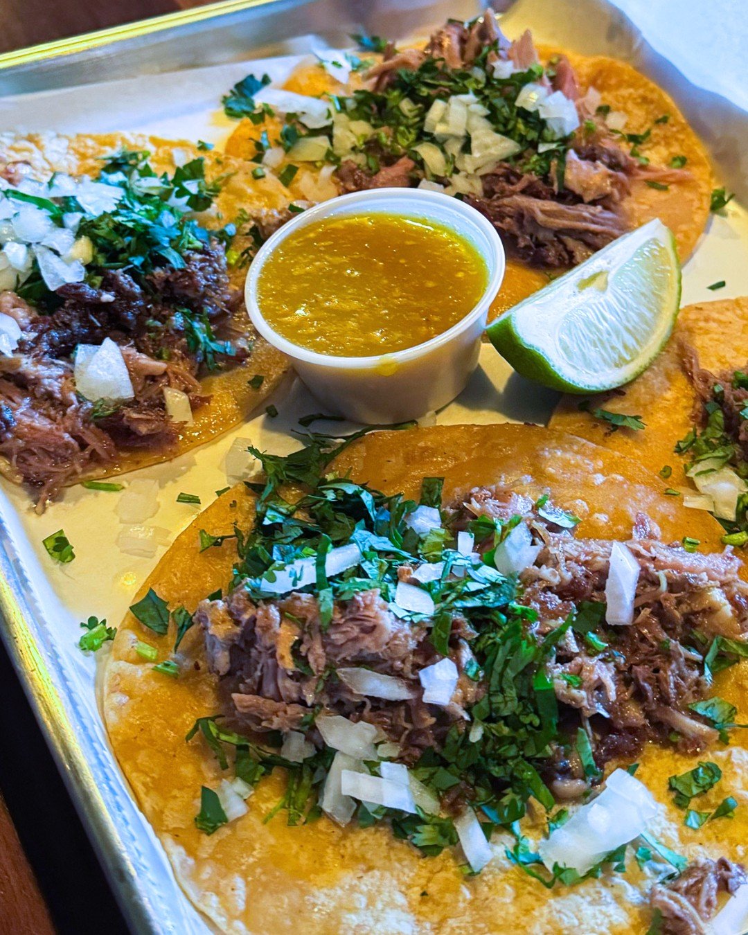 Forget Taco Tuesday, It&rsquo;s Tacos Today!
This weekend&rsquo;s special is juicy, seasoned slow-cooked pork tucked into warm tortillas, topped with fresh cilantro and chopped onions. Served with a bright green salsa that brings just the right kick.