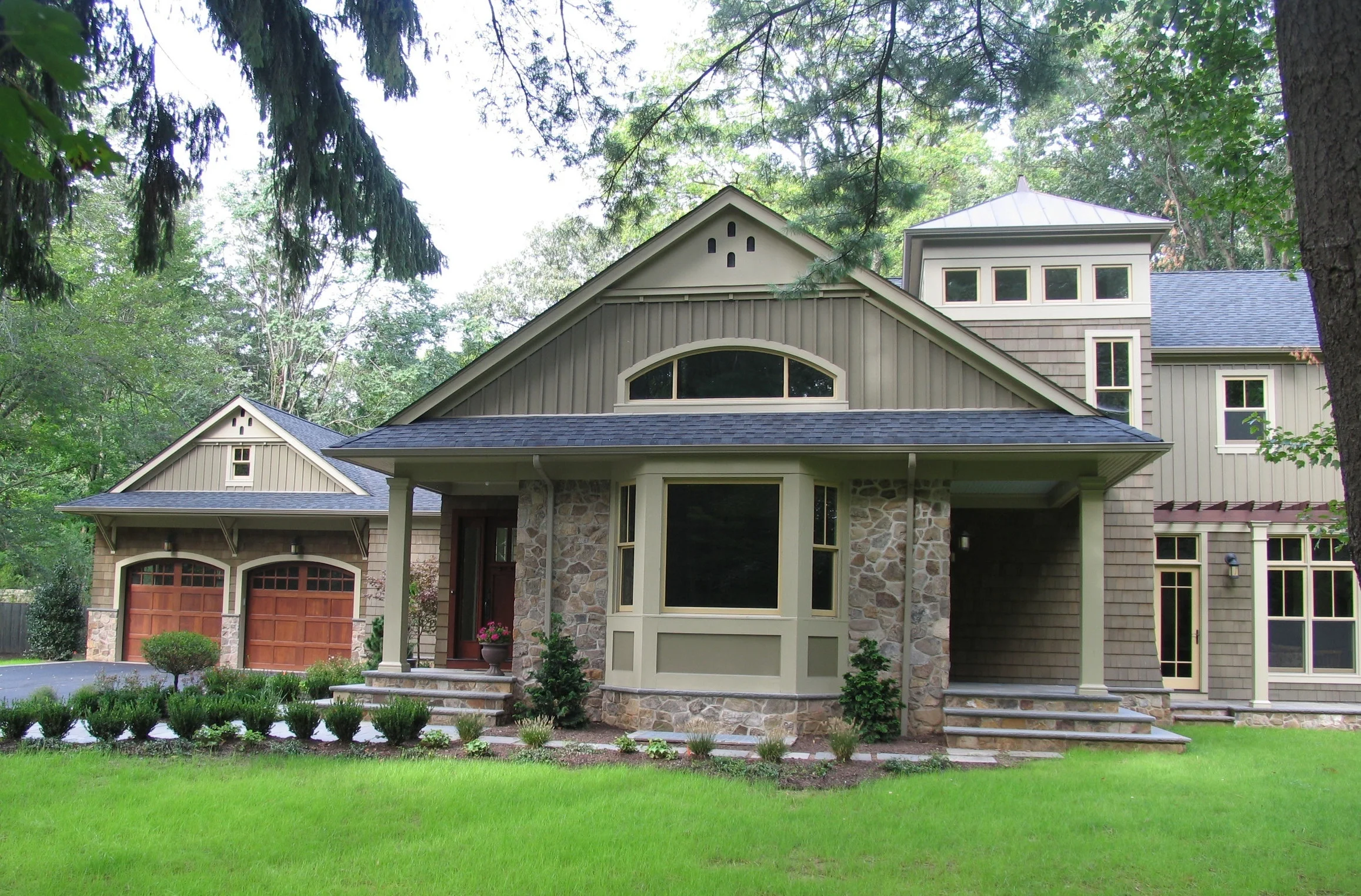 This new 3500 sqft residence is located on a flag lot in a wooden suburban setting, Our clients wanted a nicely scaled and spacious home, one that optimized natural light and responded to the privacy and wooded views this flag lot could afford. The house is sited towards the front of the flag lot to preserve a large wooded back yard, and to optimize passive solar gain. To keep this relatively small house feeling spacious we developed an open floor plan while maintaining the formal / informal relationships typical of most homes. The living room and dining room are one large space, the family room opens to the dining room as well as the kitchen / breakfast areas. Abundant in the first floor plan is access to the outside through screen porches, arbored terraces, covered porch and even a balcony off the master bedroom.