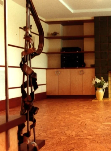  Basement renovation featuring ornamental metal stair railing, floating cork floor, birds eye maple cabinetry and mahogany banding and paneling. The horizontal banding is intended  to create both visual drama as well as increasing vertical scale of 8