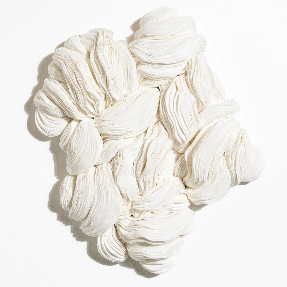 natural fabric textile wall sculpture in organic shapes by Sienna Marts @ Soapbox Arts Gallery in Burlington, Vermont