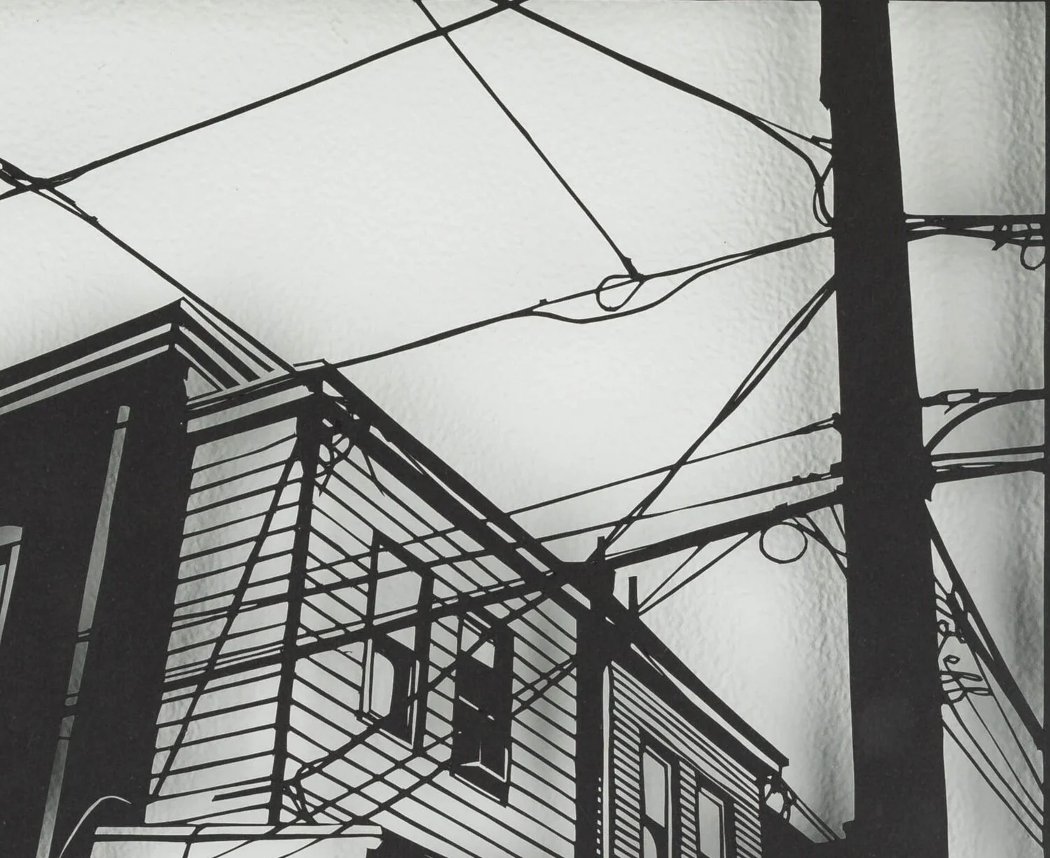 Handcut paper artwork featuring urban scene of buildings and telephone wires by Rosa Leff in floating frame