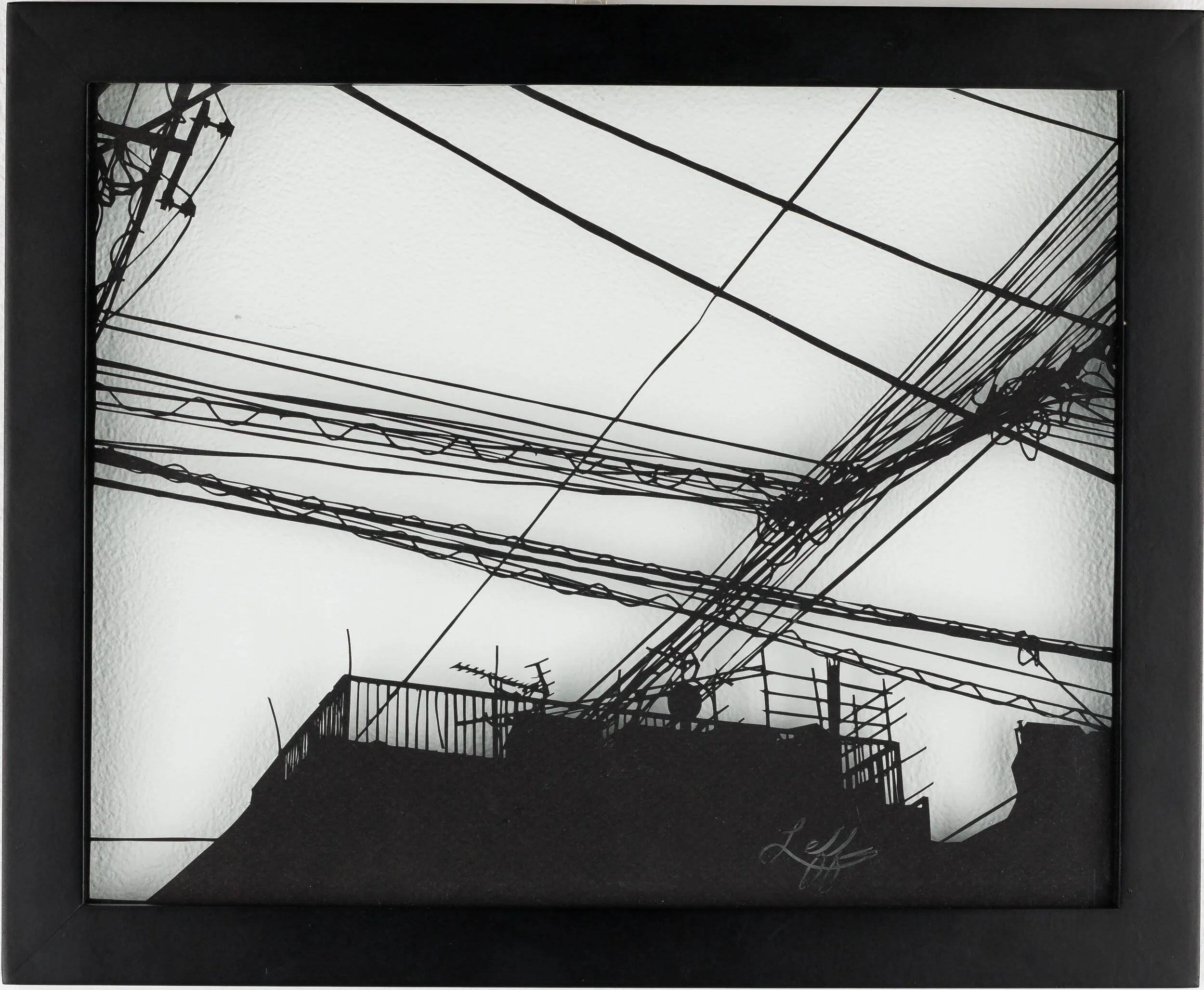 framed handcut paper artwork featuring urban scene of buildings and telephone wires by Rosa Leff 