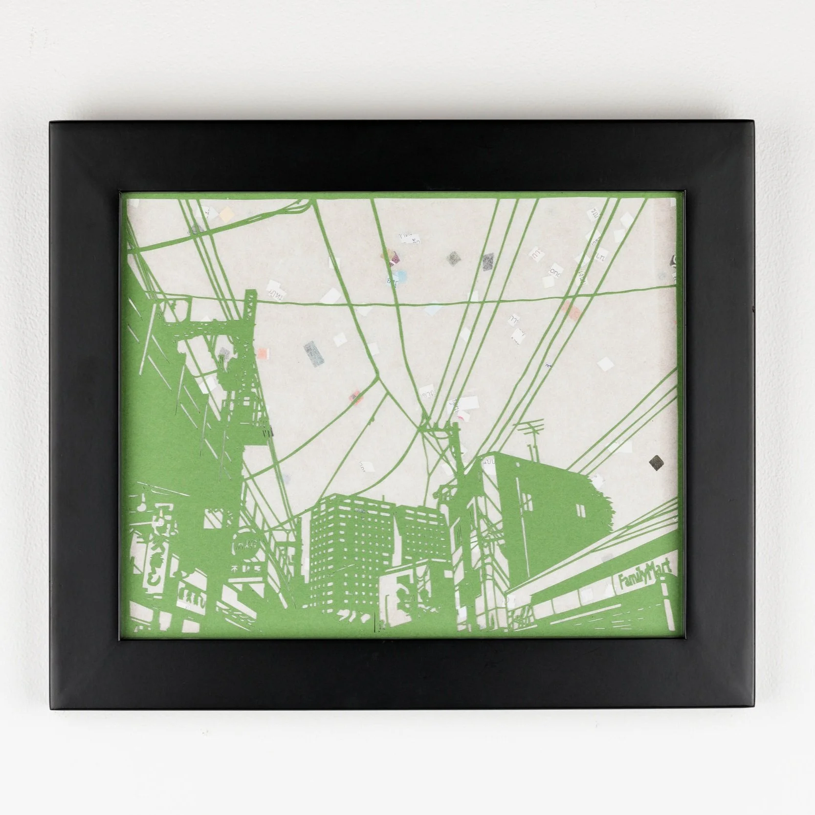 framed handcut paper artwork featuring urban scene of buildings and telephone wires by Rosa Leff 