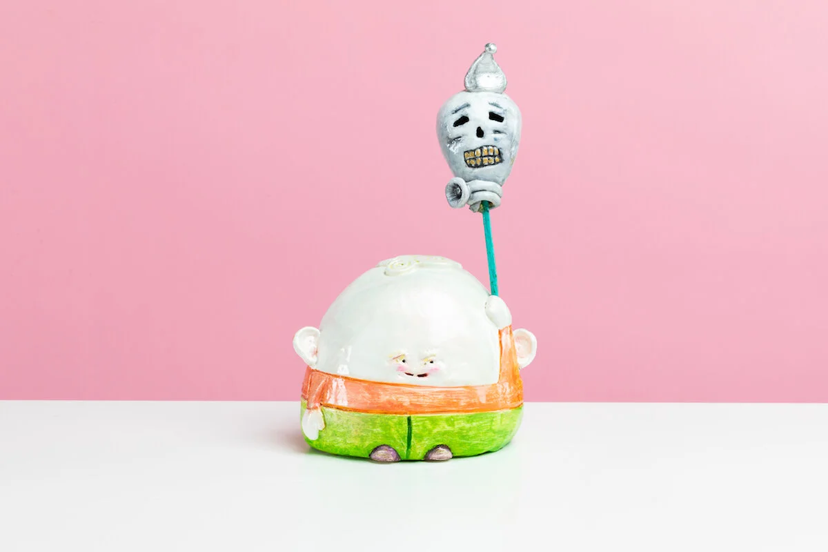 Surreal Humorous Original Hand-built Ceramic Sculpture of Evil Child with Balloon by Burlington-Based Ceramicist Jennifer McCandless