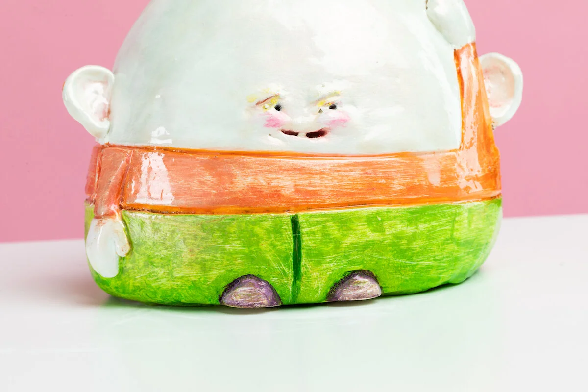 Surreal Humorous Original Hand-built Ceramic Sculpture of Evil Child with Balloon by Burlington-Based Ceramicist Jennifer McCandless