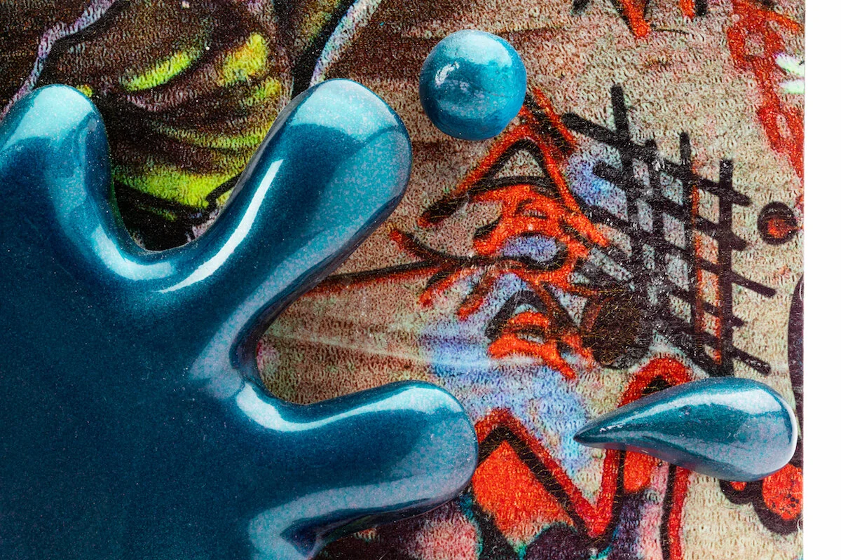 unique ceramic and mixed media sculpture by ceramicist Jennifer McCandless of hedgehog hiding in graffiti art black and white pattern with blue splatters at Soapbox Arts Gallery