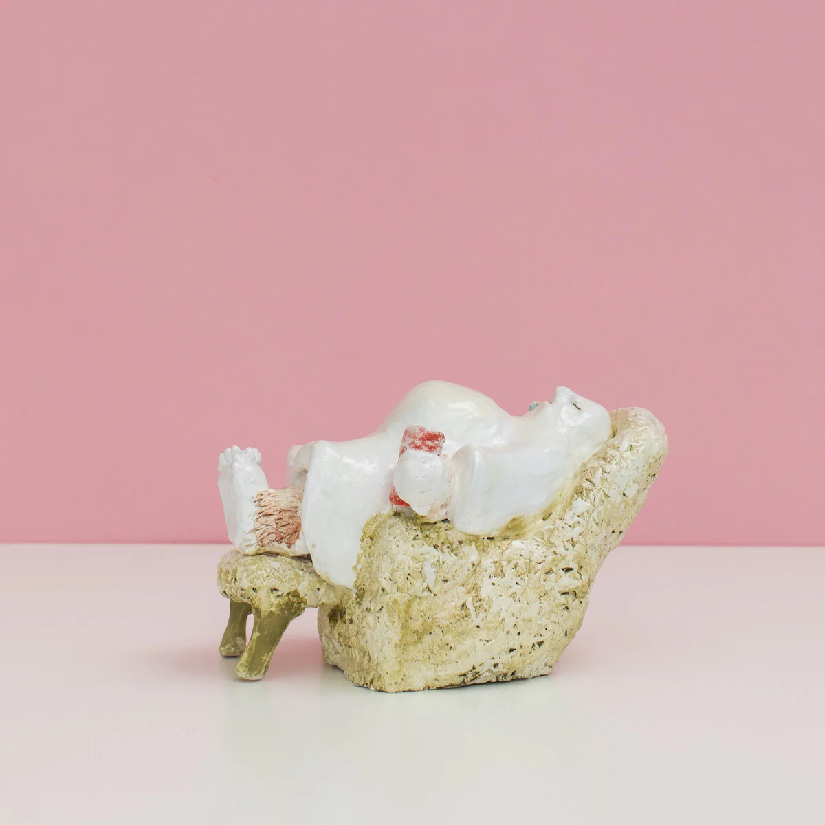 humorous hand built and painted ceramic sculpture of a ghost laying in an armchair with a can of soda  by Jennifer McCandless available through Soapbox Arts