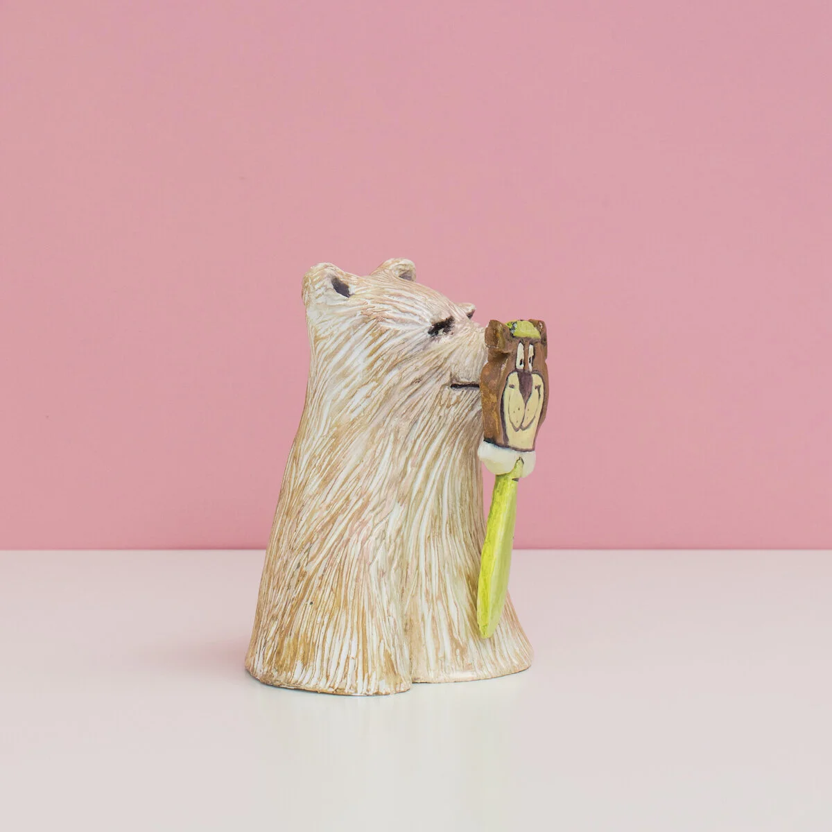 humorous hand built and painted ceramic sculpture of a bust of a bear wearing a mask of Yogi the cartoon character by Jennifer McCandless available through Soapbox Arts