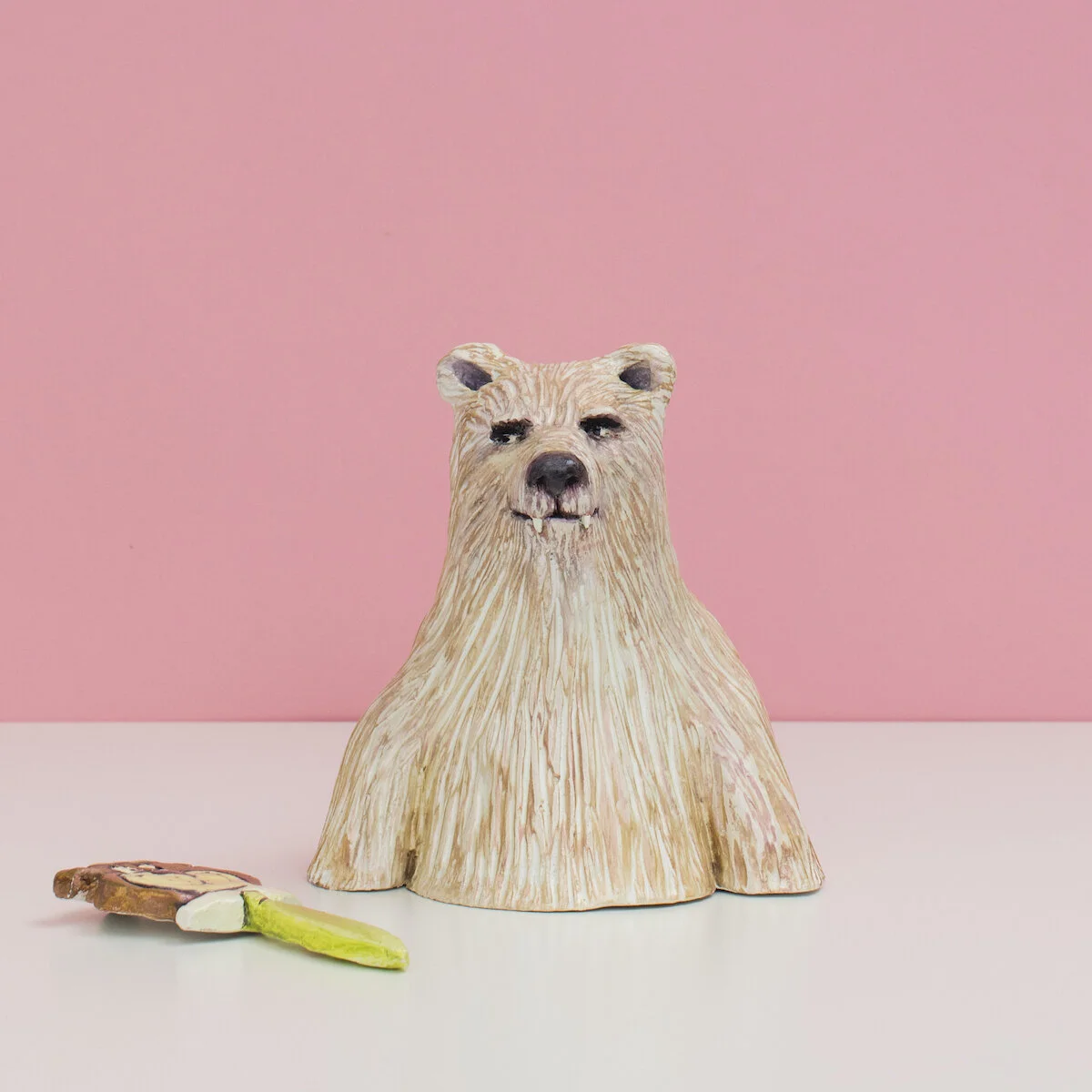 humorous hand built and painted ceramic sculpture of a bust of a bear wearing a mask of Yogi the cartoon character by Jennifer McCandless available through Soapbox Arts