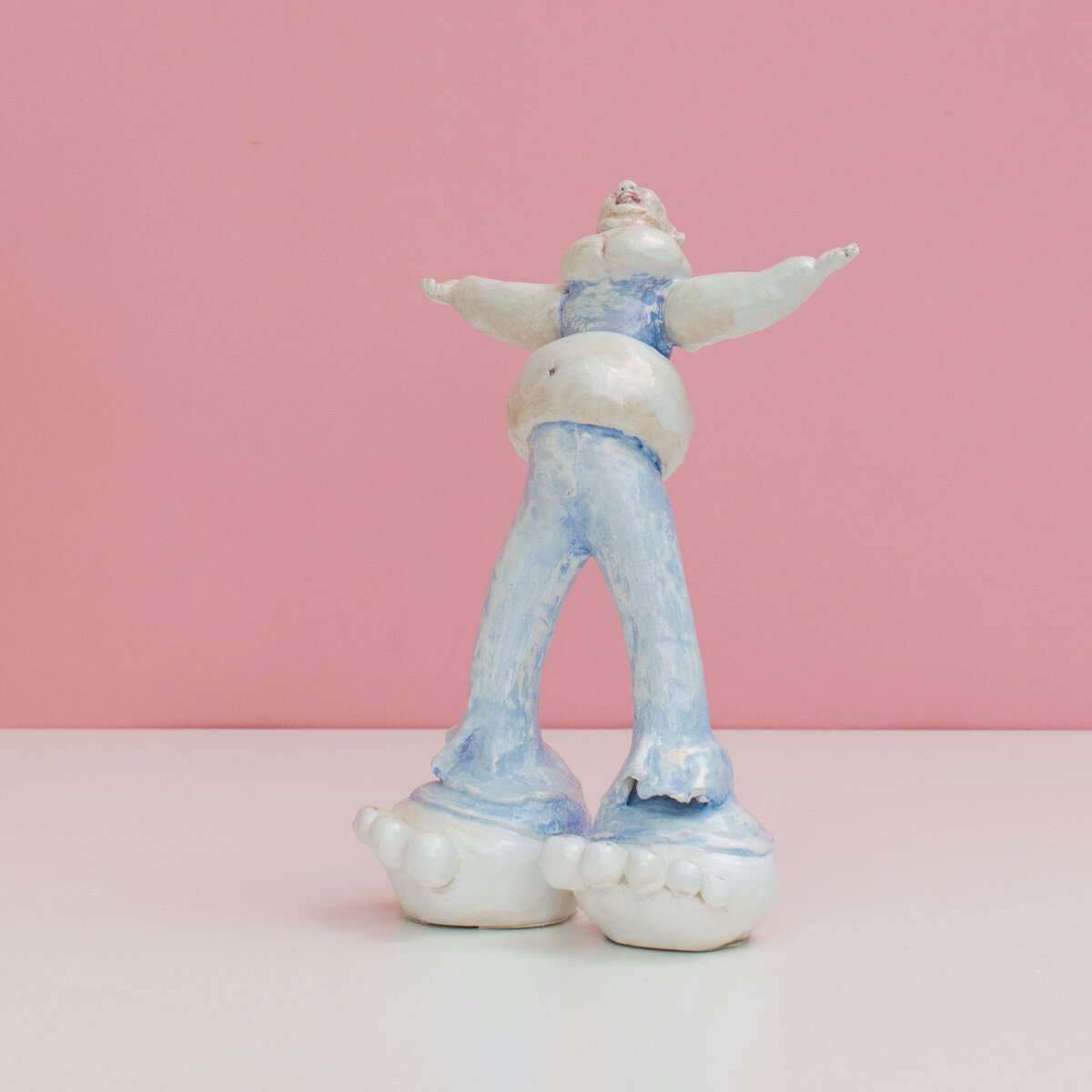 humorous hand built and painted ceramic sculptures of small women squeezing into tight fitting clothing in flailing positions by Jennifer McCandless available through Soapbox Arts