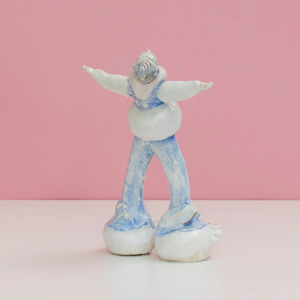 humorous hand built and painted ceramic sculptures of small women squeezing into tight fitting clothing in flailing positions by Jennifer McCandless available through Soapbox Arts