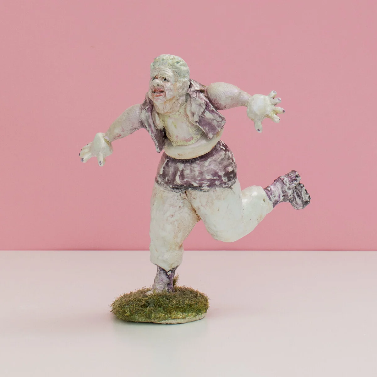 humorous hand built and painted ceramic sculptures of small women squeezing into tight fitting clothing in flailing positions by Jennifer McCandless available through Soapbox Arts