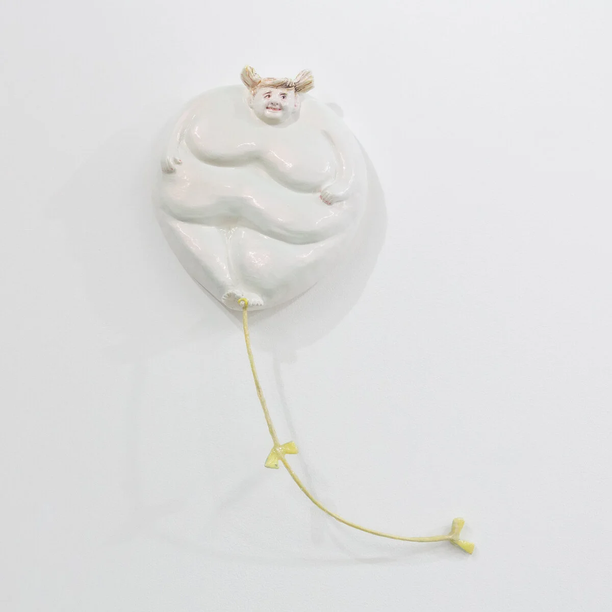 humorous hand built and painted ceramic sculpture of a round, floating female figure resembling a balloon with a string  by Jennifer McCandless available through Soapbox Arts