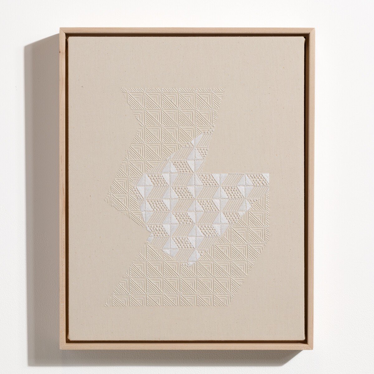 hand embroidered artwork with white thread on cotton canvas in geometric patterns by Alice Wiese for Soapbox Arts Gallery in Burlington, Vermont