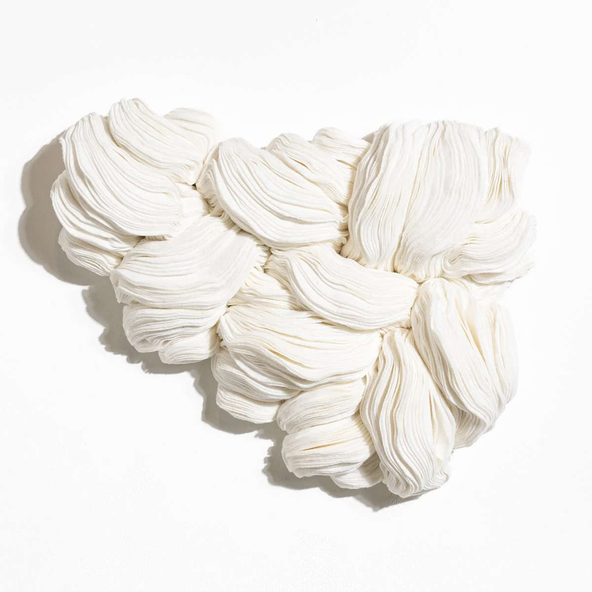 natural fabric textile wall sculpture in organic shapes by Sienna Marts @ Soapbox Arts Gallery in Burlington, Vermont