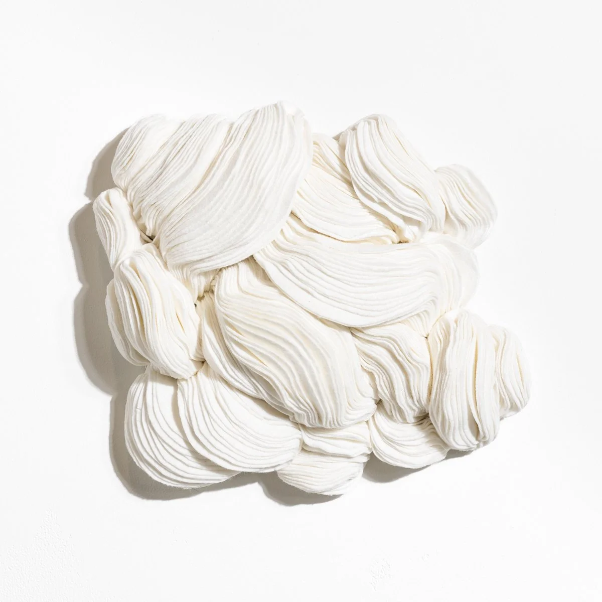 natural fabric textile wall sculpture in organic shapes by Sienna Marts @ Soapbox Arts Gallery in Burlington, Vermont